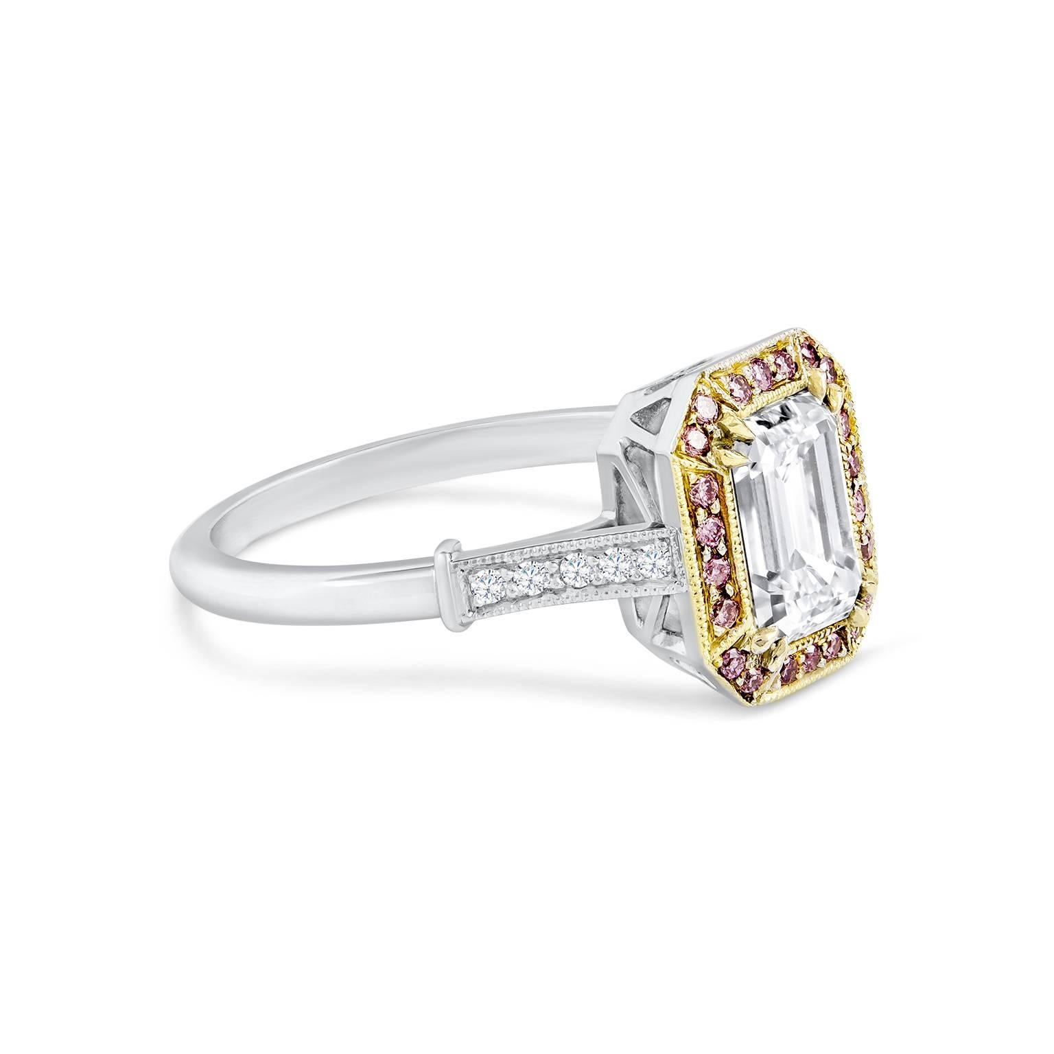 Aa colorful engagement ring designed to have an antique look. Showcasing a gorgeous beautiful 1.52 carat emerald cut diamond that GIA certified as F color, VVS2 clarity. Surrounding the center are 0.15 carats total of pink diamonds set in a yellow