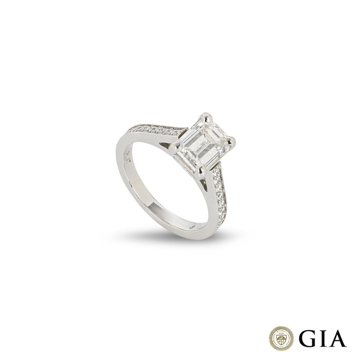 A beautiful diamond platinum engagement ring. The ring comprises of a emerald cut diamond with a weight of 1.51ct, F colour and VVS2 clarity in a 4 claw setting. Complementing this centre diamond are 9 round brilliant cut diamonds on each shoulder