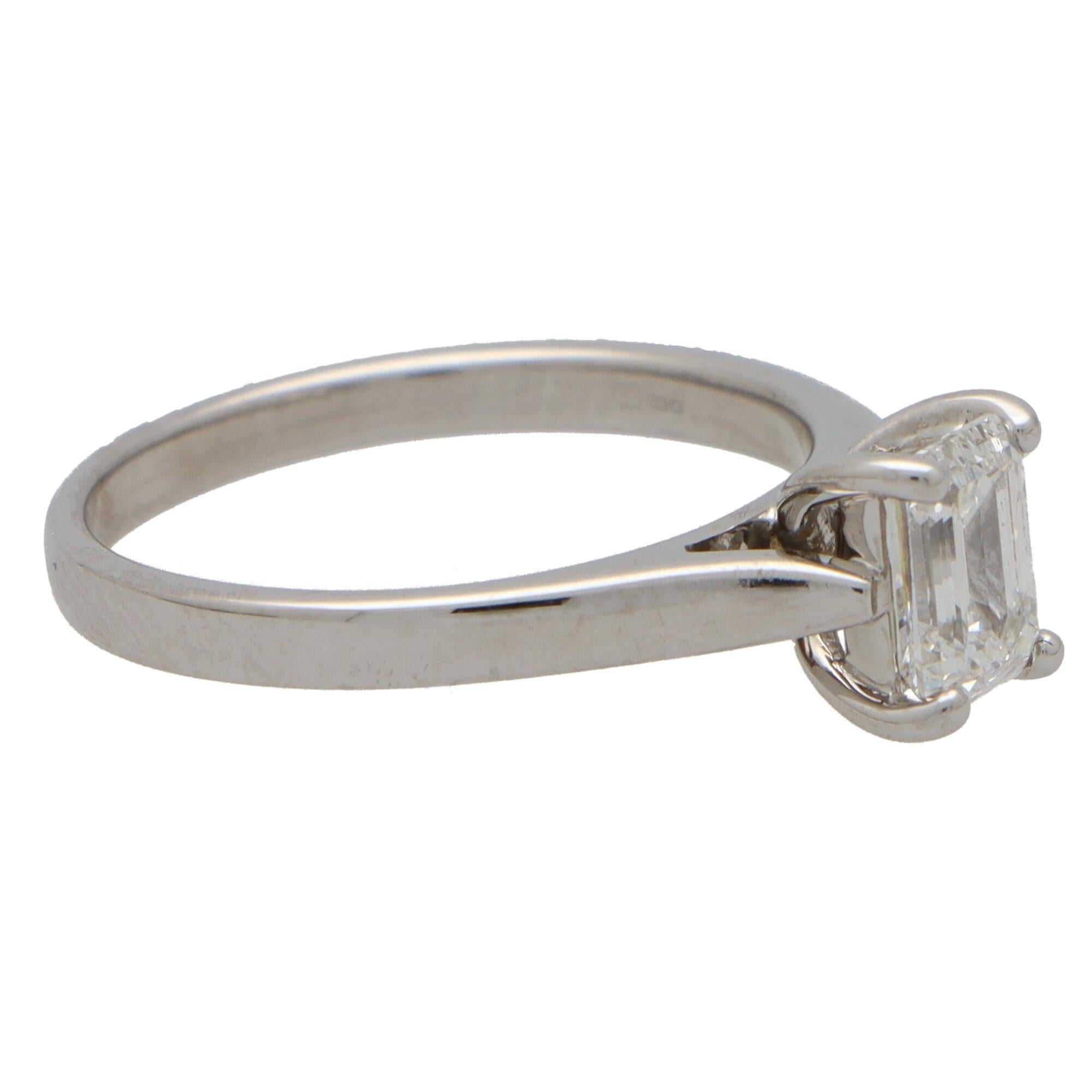 An extremely elegant emerald cut diamond single solitaire engagement ring set in 18k white gold.

The piece solely features a beautiful certified 0.91 carat emerald cut diamond. The diamond is four claw set to centre within a v-shaped double gallery