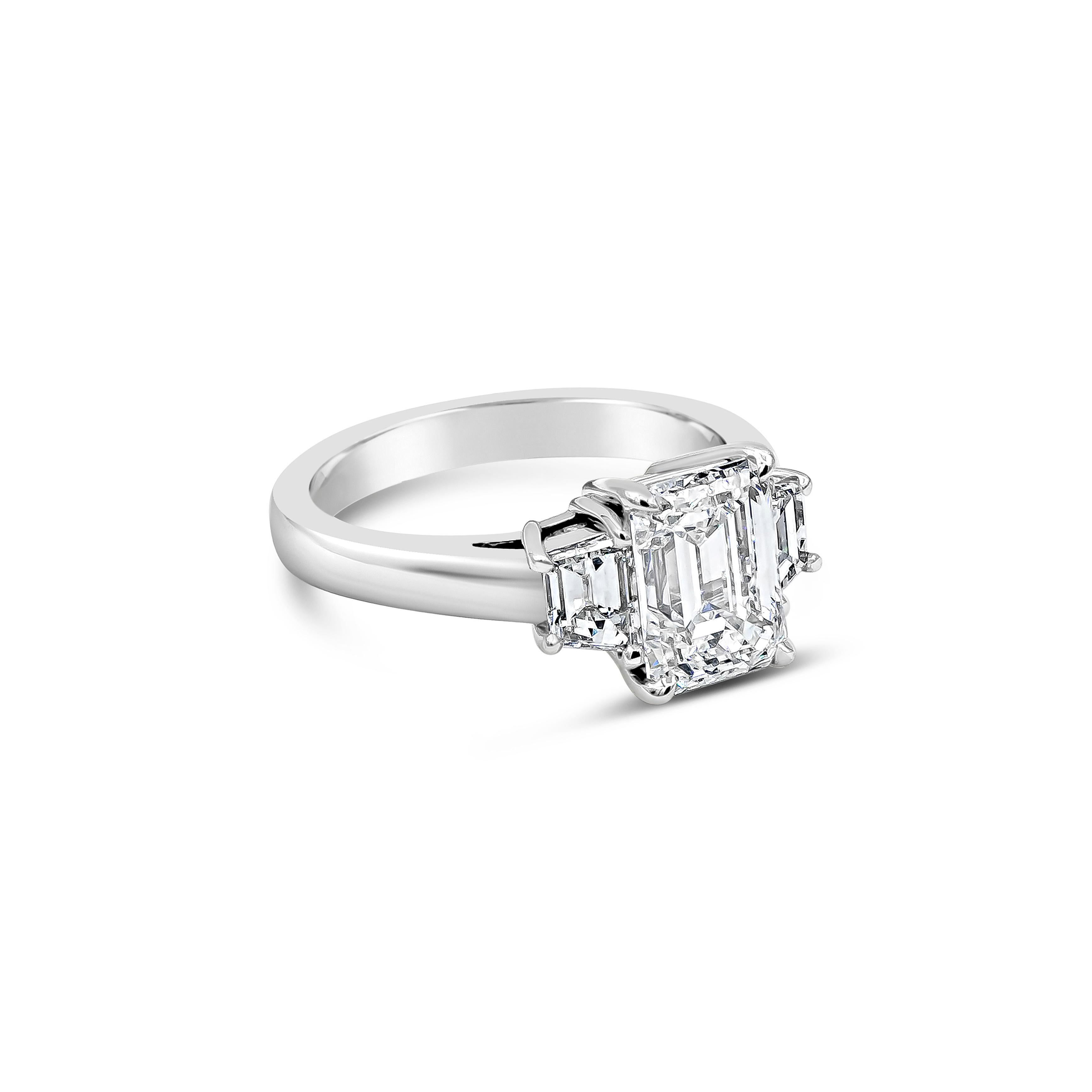 A simple and timeless engagement ring design showcasing a 2.12 carat emerald cut diamond certified by GIA as G color, VS2 clarity. Flanking the center are step-cut trapezoid diamonds weighing 0.69 carats total. Set in a platinum mounting.

Style