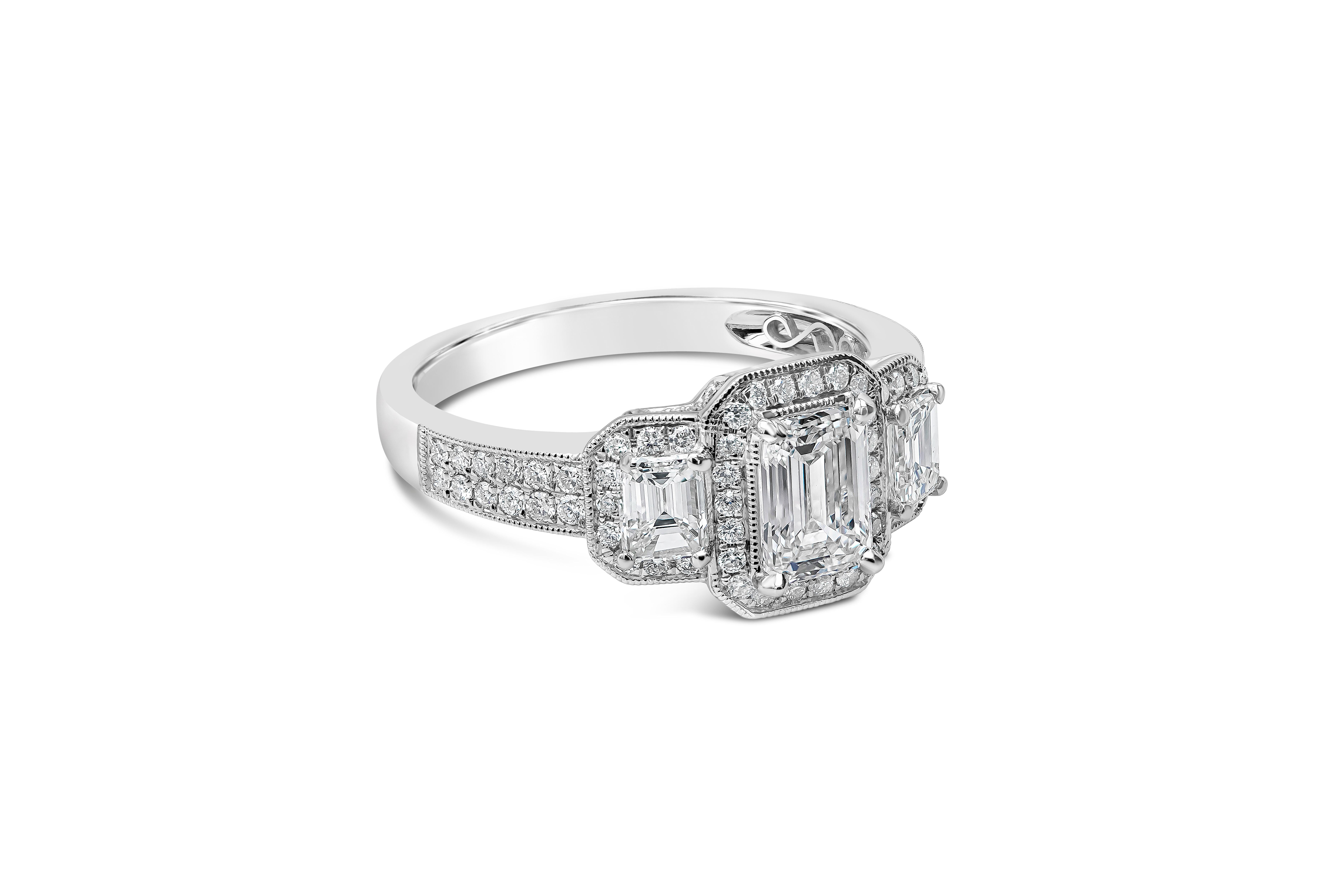 An antique-style engagement ring showcasing a 0.75 carats emerald cut diamond certified by GIA as H color, VVS1 in clarity. Flanking the center diamond are two emerald cut diamonds set in a round brilliant diamond halo. Accent diamonds weigh 0.78