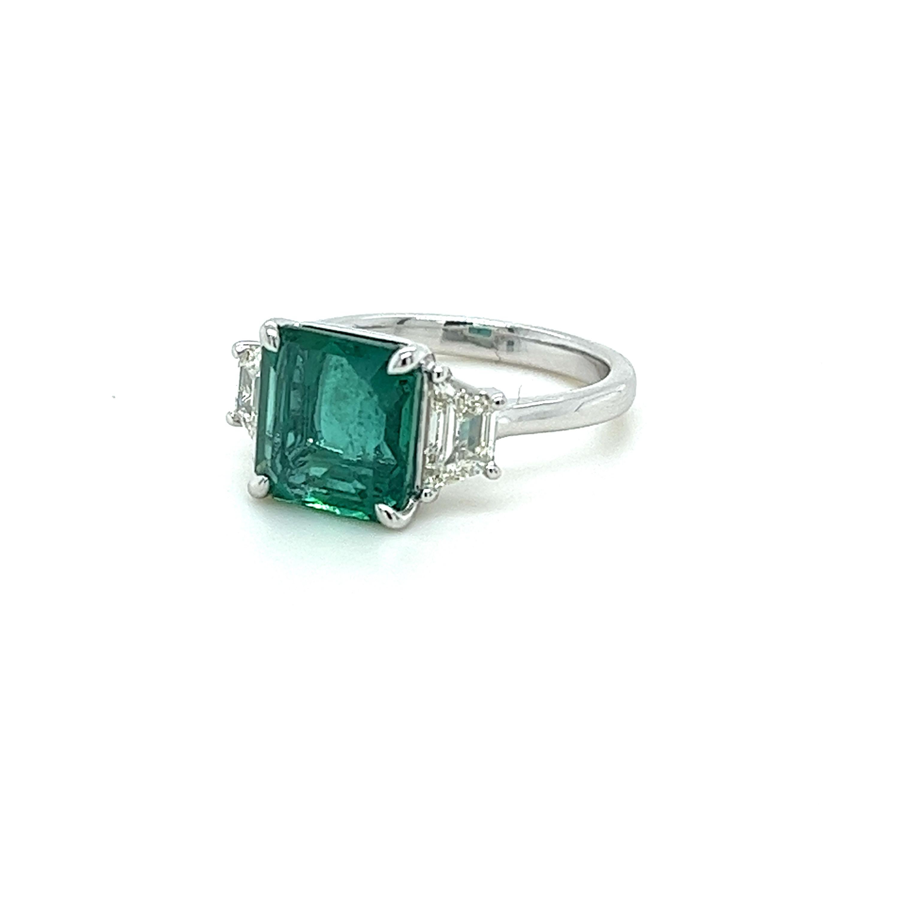 GIA Certified Squarish Emerald Cut Emerald weighing 3.66 carats
Measuring (9.54x9.07x5.21) mm
Trapezoid Diamonds weighing .79 carats
I-SI1 quality diamonds
Set in platinum ring
7.00 grams