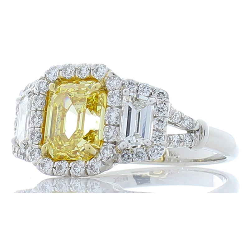 Unbelievable and one-of-a-kind! This ring showcases a captivating 2.27 carat emerald cut fancy vivid yellow diamond, VS1, that measures 7.79 x 6.57 millimeter. To find an emerald cut that is vivid yellow is extremely rare - it is auction worthy. The