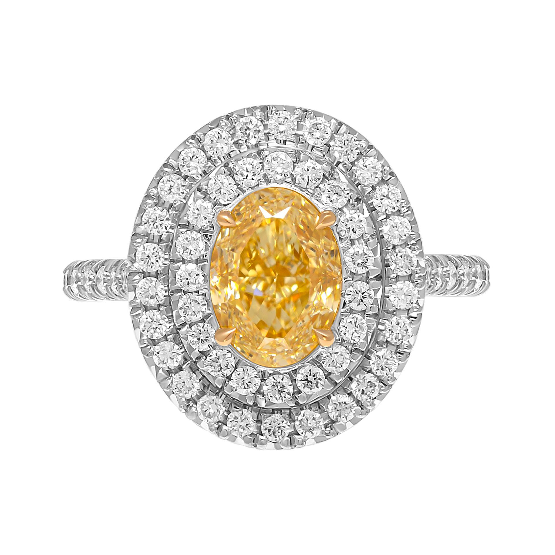 Engagement ring mounted in 18K Yellow Gold & Platinum 
Double halo &  cathedral shank encrusted with pave diamonds totaling 0.64ct F-G color and VS clarity
Center Stone: 1.65ct Natural Fancy Yellow VVS2 Oval  diamond GIA#2437752665
Size: 6 
Comes