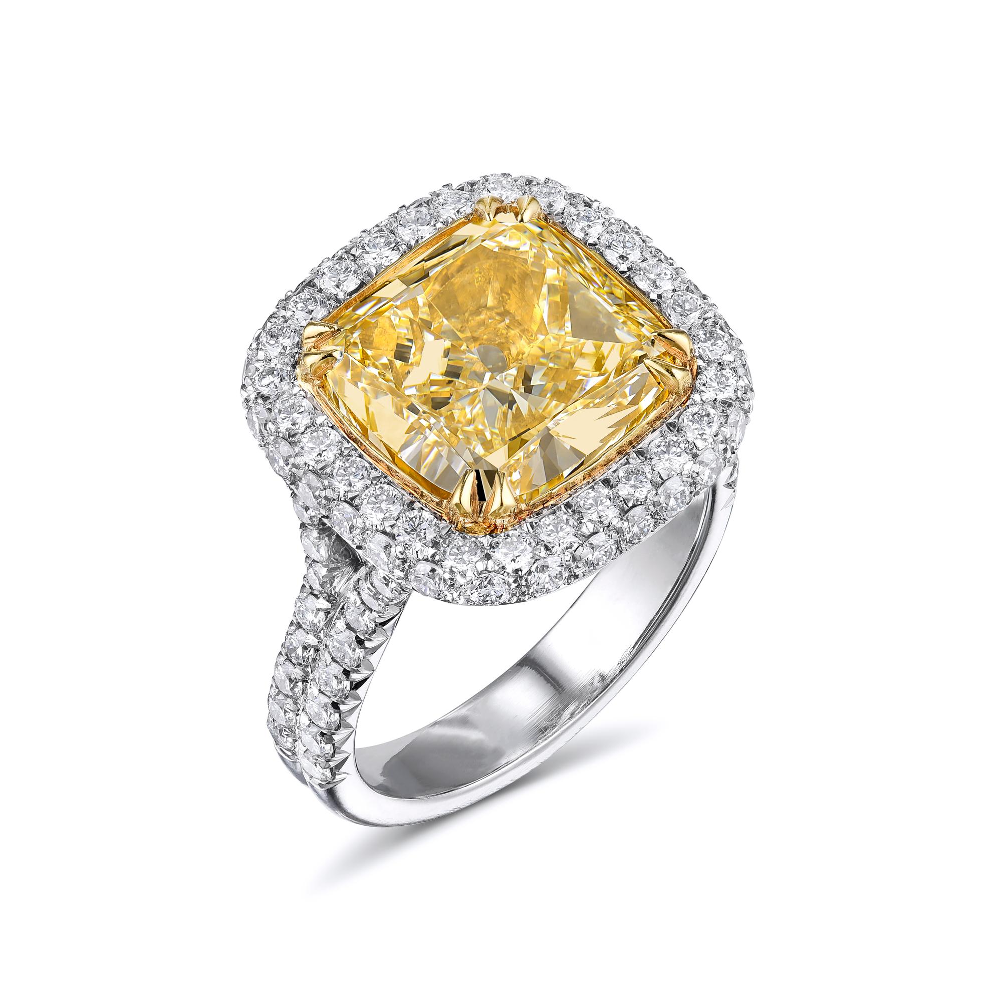 Diamond ring with GIA certificate, no.1162257236. Center stone: 6.11ct Cushion cut Fancy to Fancy Intense Yellow VS2 diamond, 10.6 x 10.4 x 6.14mm. Side stones: 1.25ct Brilliant Round diamonds: F-G VS1-SI1. Total carat weight: 7.36ct. EGL Report