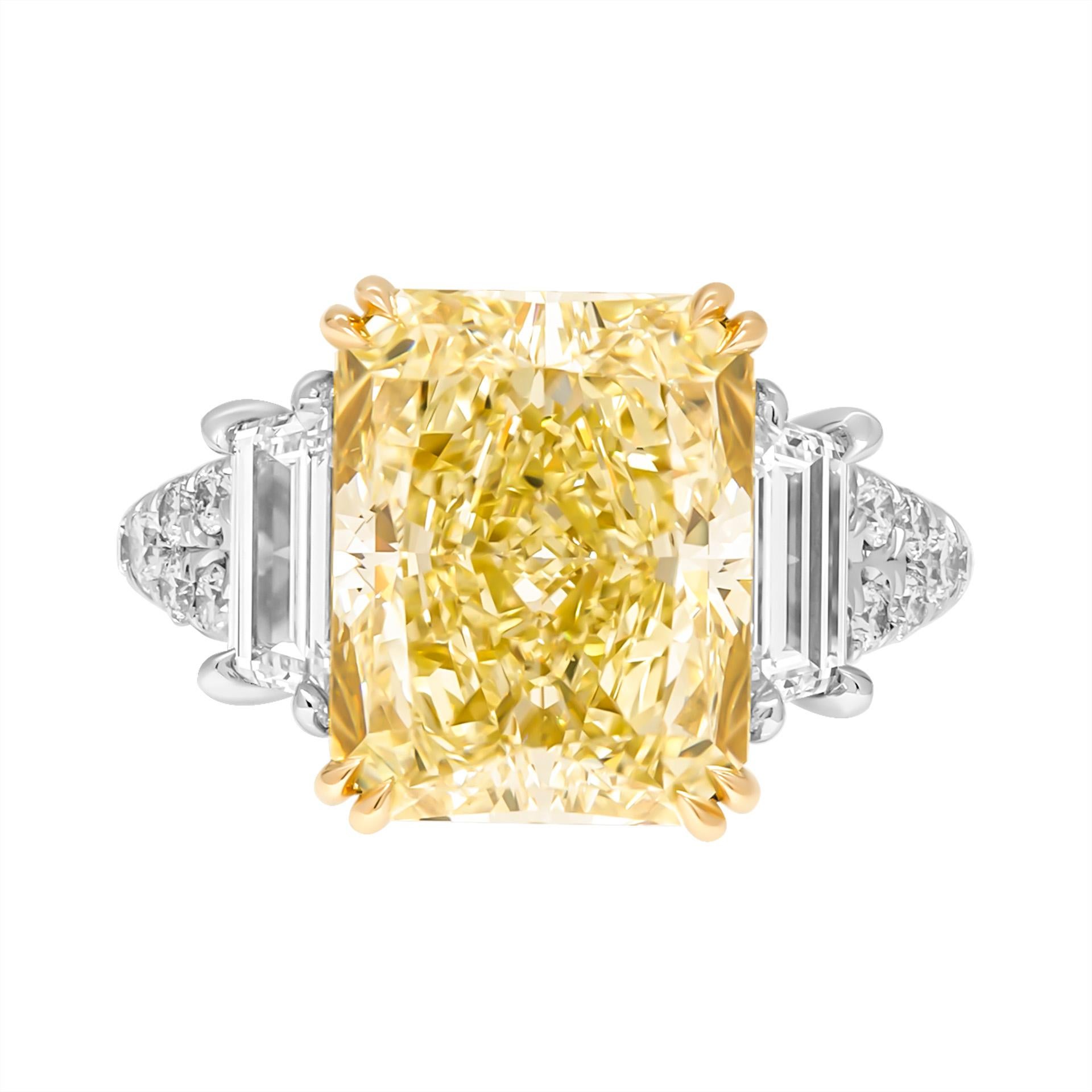 3 stone ring in Platinum & 18K Yellow Gold
Center: 6.86ct Natural Fancy Light Yellow Even VS2 Radiant Shape Diamond GIA#6224979207 

Side stones: 
Two side stones totaling 0.93ct E VVS trapezoids 
Total Carat Weight of Yellow melee stones: