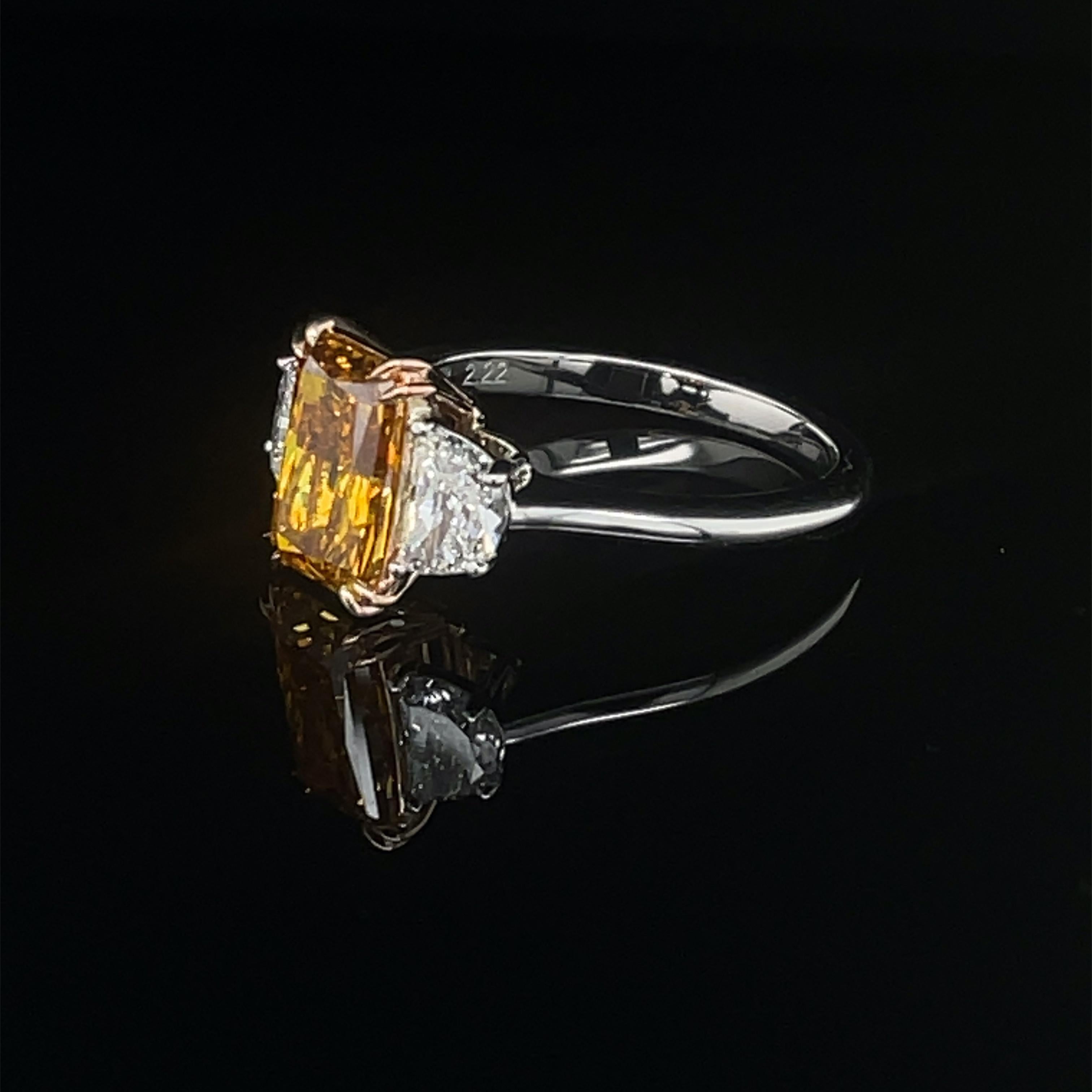 An exceptional and rare 2.22ct Fancy Deep Yellow Orange Radiant Diamond 
set in a platinum ring with 
2 Half Moon diamonds = 0.73cttw
GIA Certificate #5211956986
The color of this diamond is exceptional and rare and a diamond like this one enters