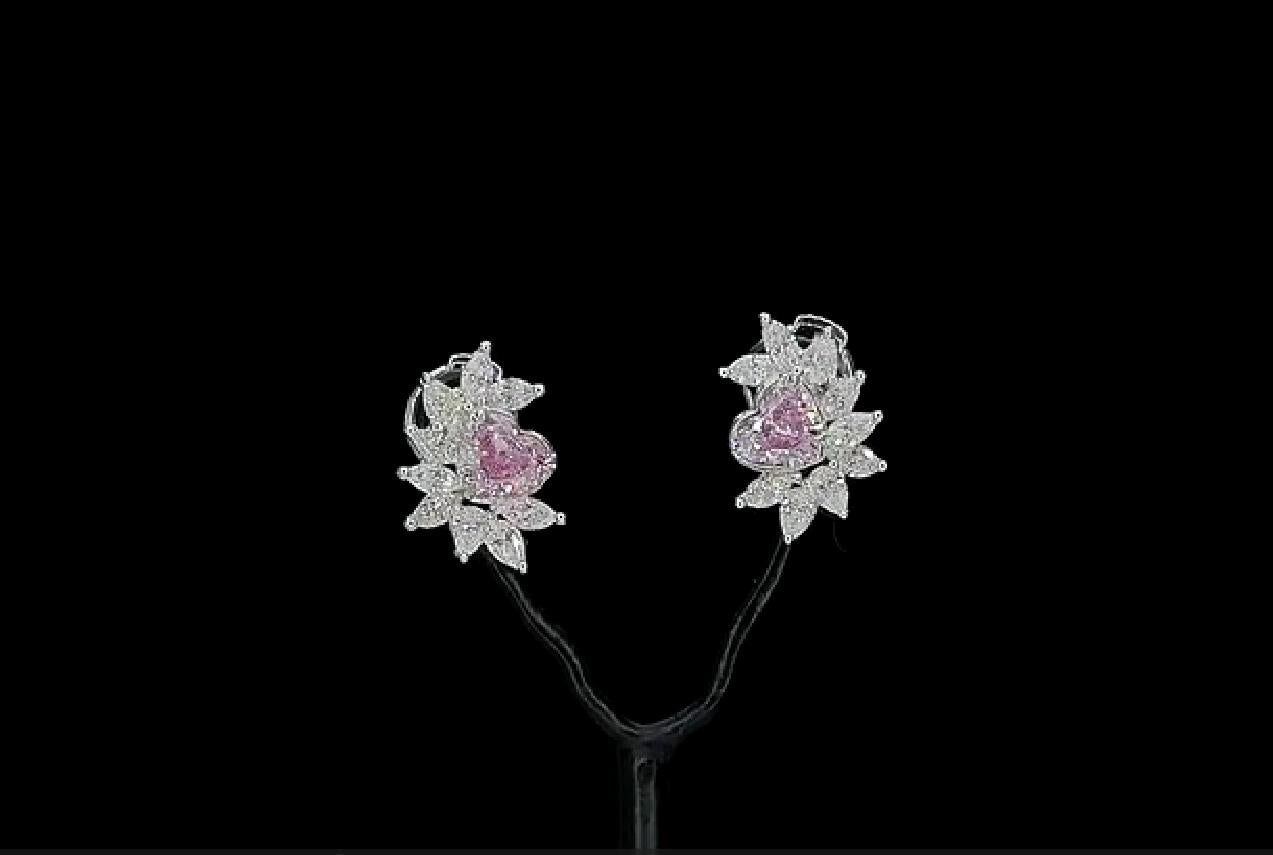 18kt white gold earrings with diamonds
  
  Gold colour & karat: White gold 18kt
  Weight: 2.91 grams
  
  Set with-
  Stone type: Diamonds
  Shape: Heart
  Carat: 0.38 ct, 0.32 ct
  Colour: Faint Pink, Fanit Pink
  Clarity: VS1, VVS2
  
 