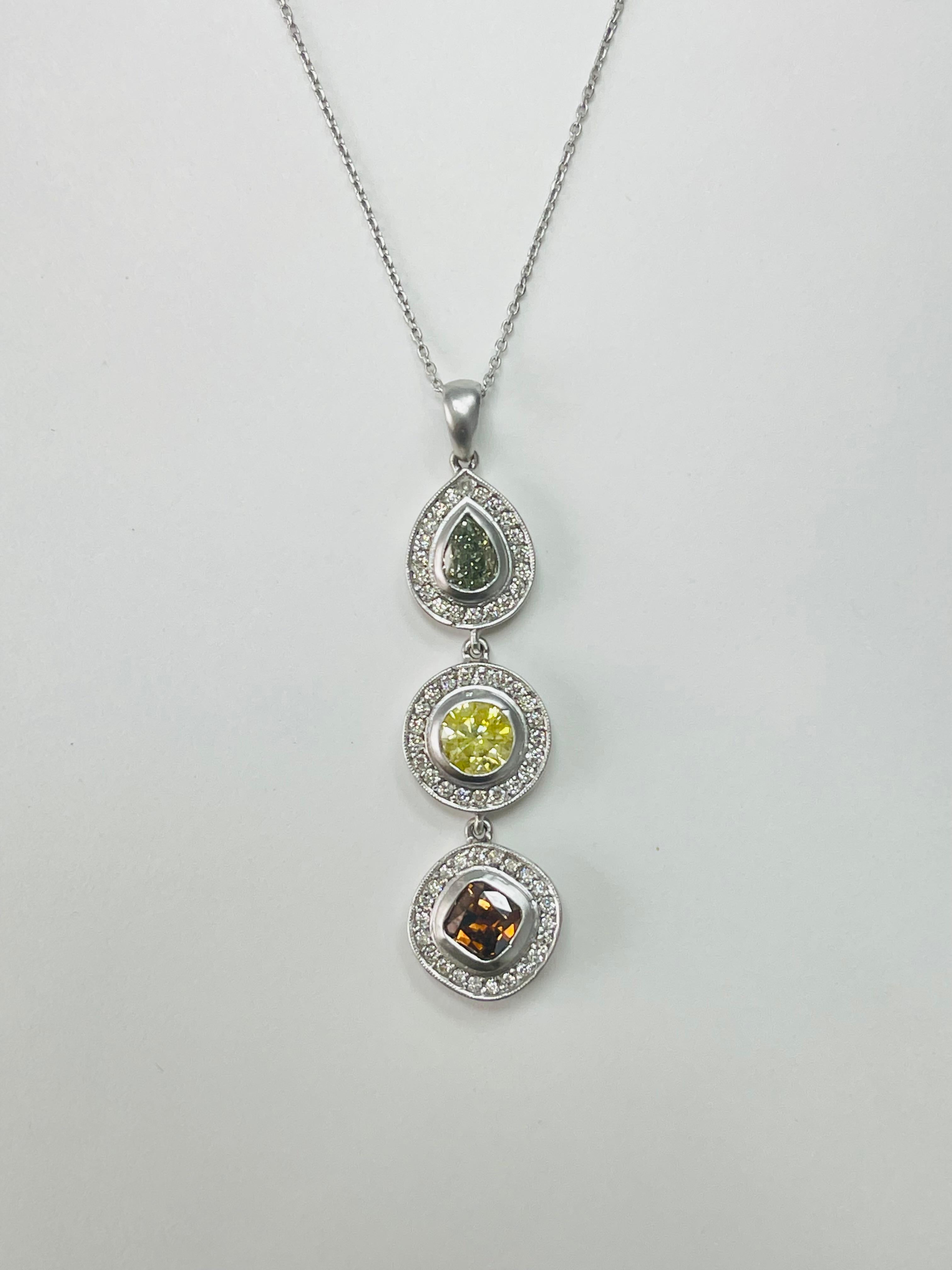 Beautifully hand made fancy color diamond Pendant In 18k white gold. 
Three fancy color diamonds are set in a straight line to give it an elegant and a classy look.
The details are as follows : 
Pear shape fancy color diamond : 0.51 carat ( fancy
