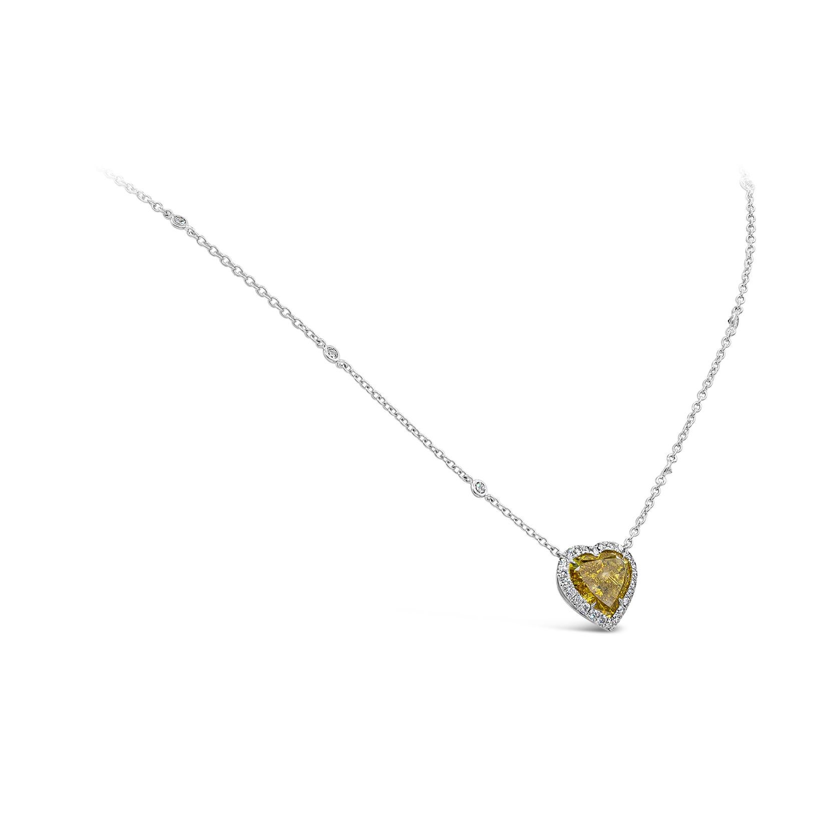 A wonderful pendant necklace, showcasing a vibrant 4.02 carats heart shape diamond certified by GIA as Fancy Deep Orangy Yellow color and I1 clarity, set on a four prong setting. Surrounded by a halo of round cut diamonds and accented by a diamonds