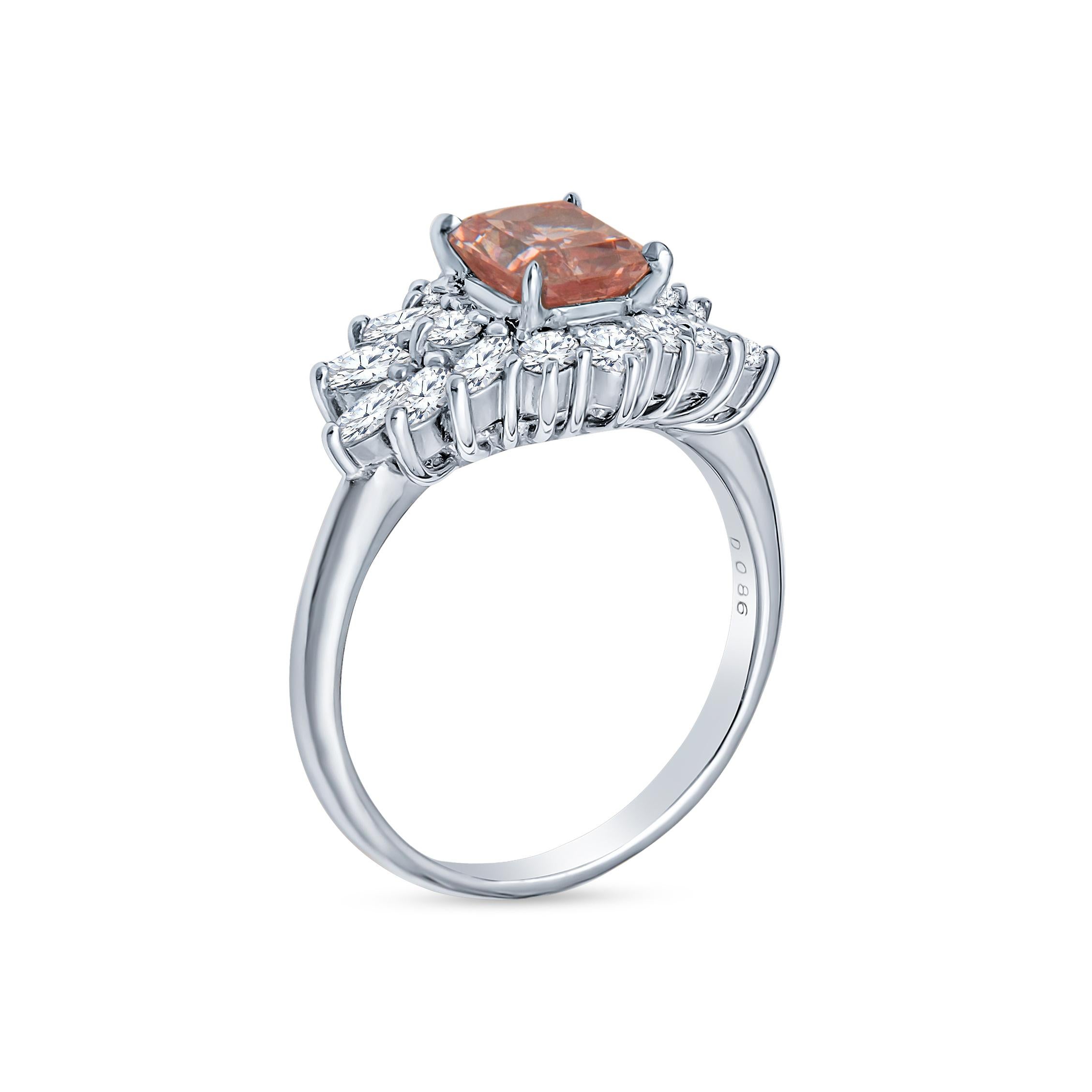This beautiful ring features a spectacular 1.09 Carat Radiant cut Natural Fancy Intense Pink Natural Diamond certified as VS1 by the GIA. It is accented with a spread of marquise and round brilliant cut diamonds weighing approximately 0.86 carats in