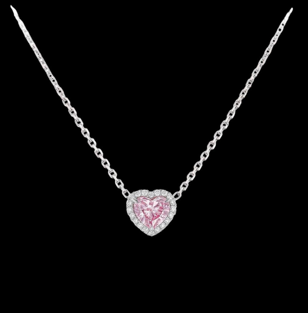 This GIA Certified Fancy Intense Purplish Pink Heart Shape Diamond Pendant is made out of 
a 0.63ct Fancy Intense Purplish Pink Heart Shape Diamond center 
Set in Platinum and Rose gold with a halo of colorless diamonds.

