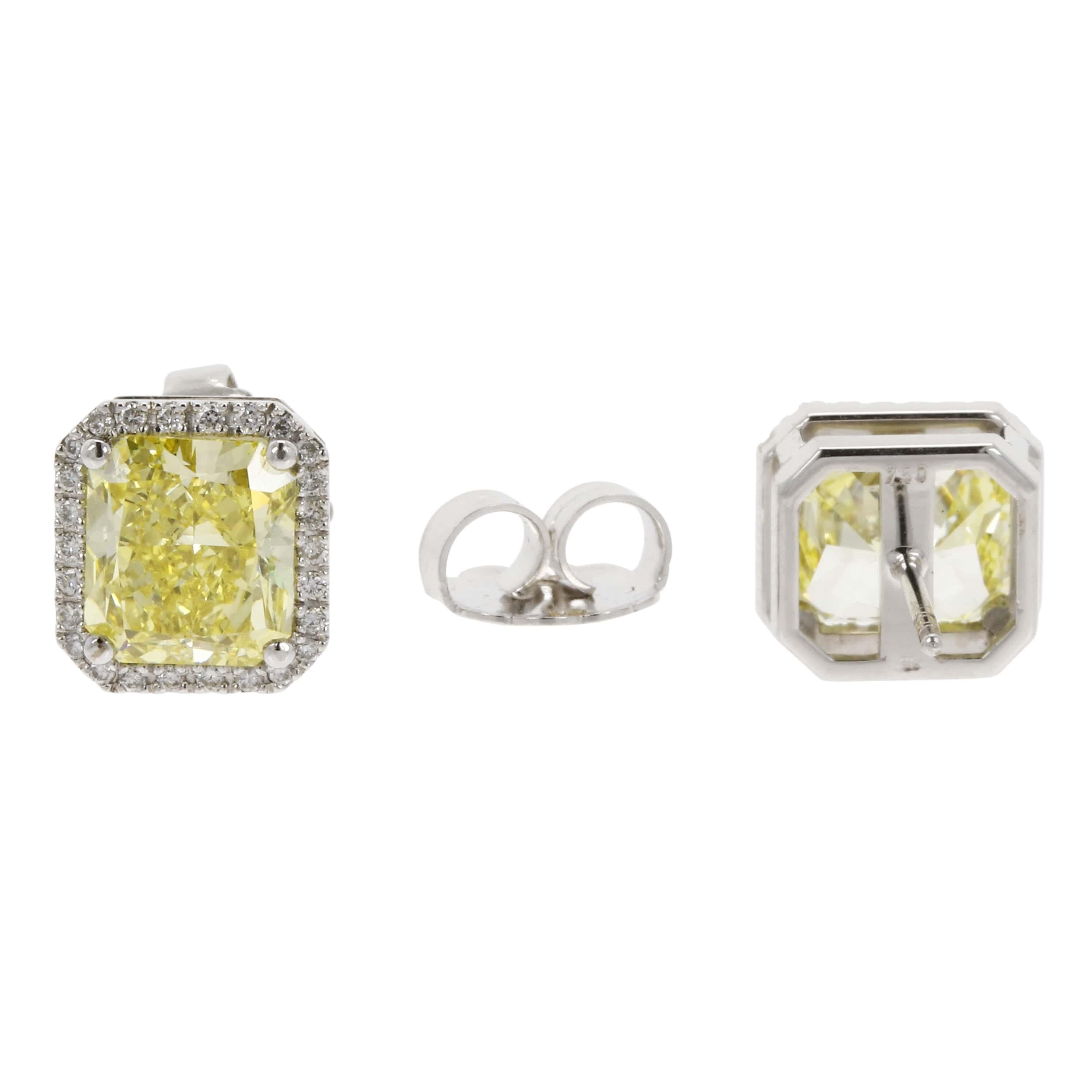 Matching pair of radiant-cut yellow diamonds, weighing 3.52 carats and 3.41 carats, set within a frame of round brilliant diamonds weighing approximately 0.70 carats in total. Accompanied by GIA diamond reports stating that the diamonds are natural