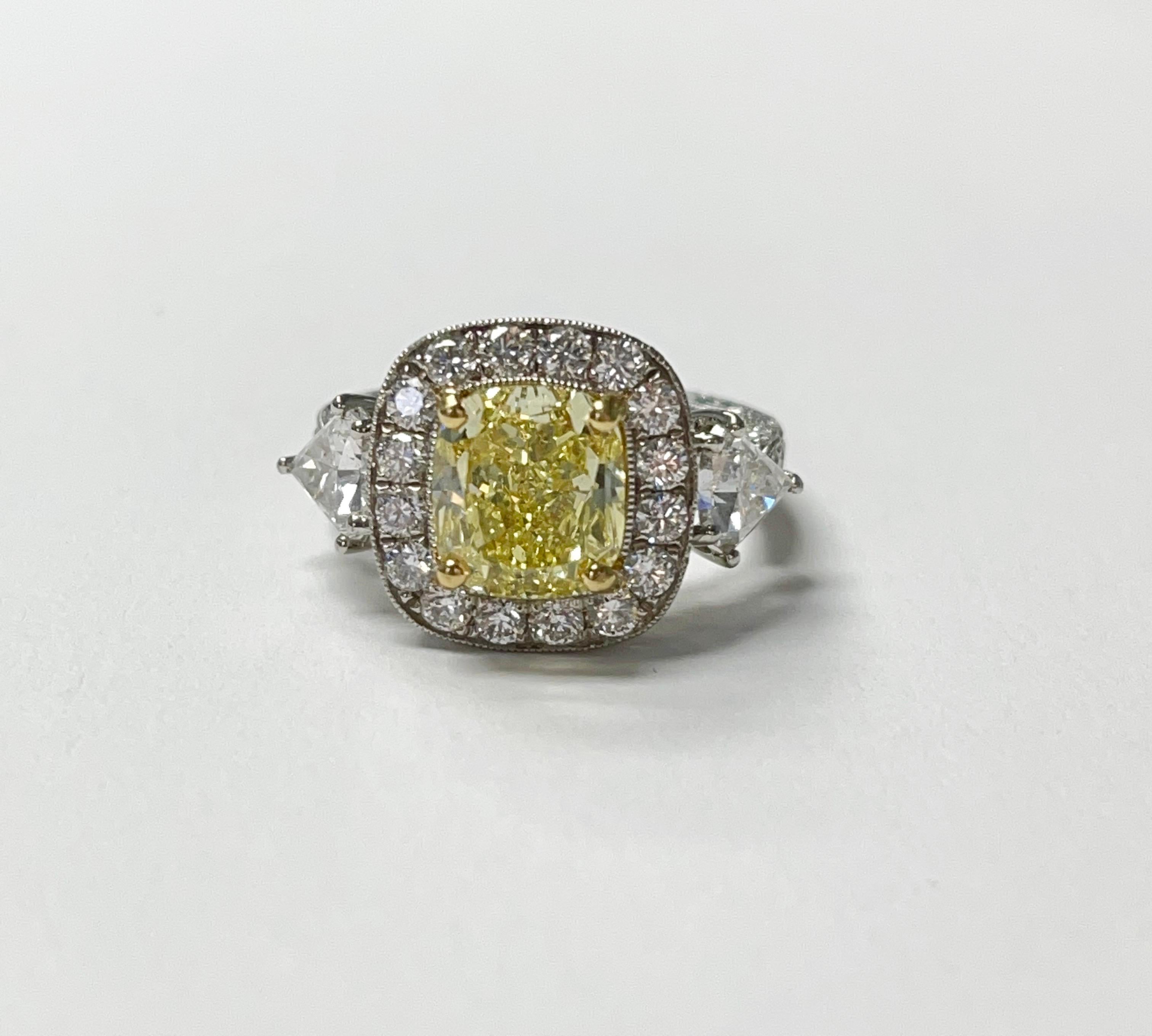 Fancy intense yellow Cushion and white diamond engagement ring handcrafted in platinum. 
Fancy intense yellow cushion weight : 3.35 carat ( VVS1 clarity ) 
Diamond weight : 5.82 carat ( GH color and VS clarity ) 
Metal : Platinum 
Measurements :