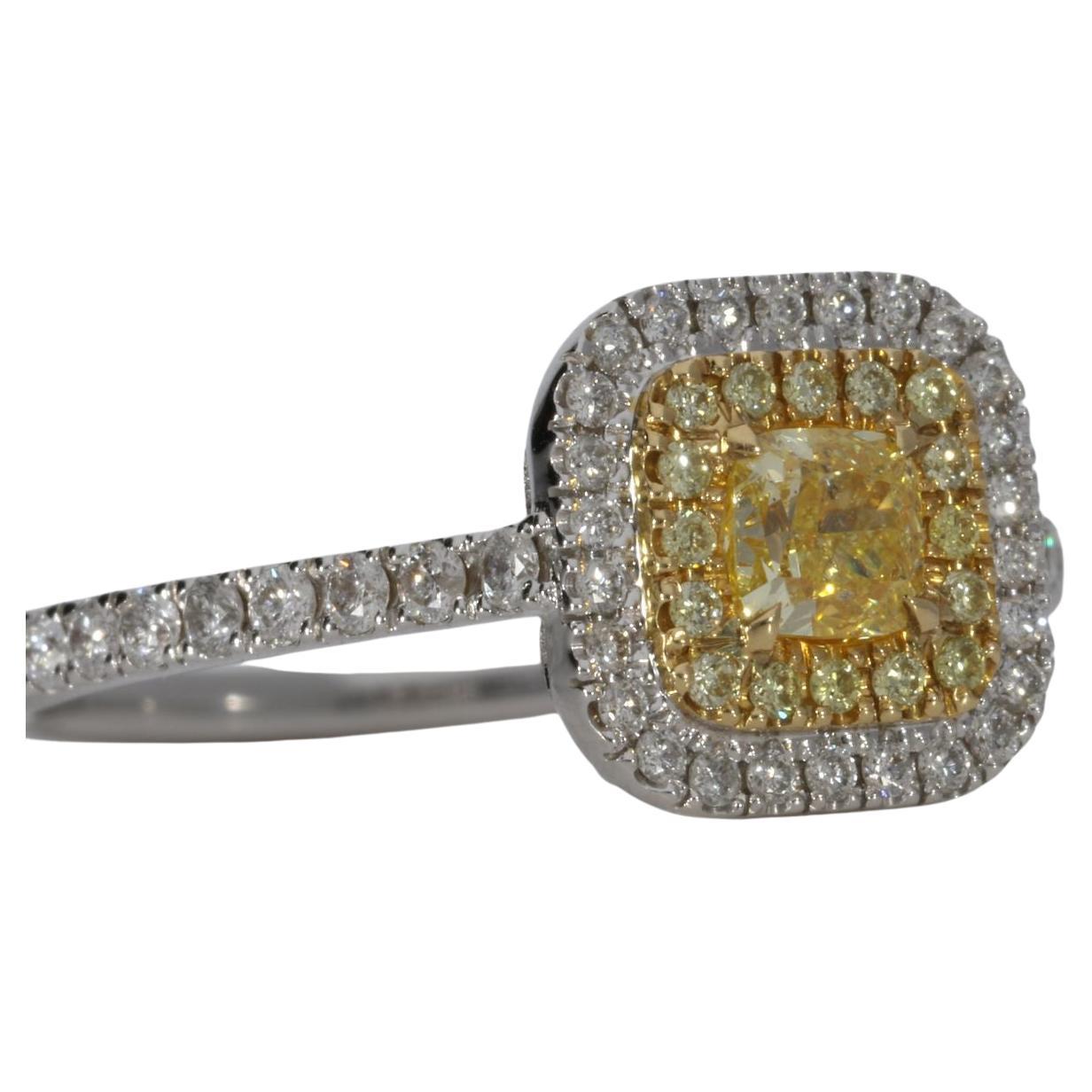 an enchanting center diamond ring featuring a captivating 0.30 carat cushion-shaped Fancy Intense Yellow diamond. This stunning central diamond radiates warmth and brilliance, making a bold statement that is sure to turn heads.

Surrounding the