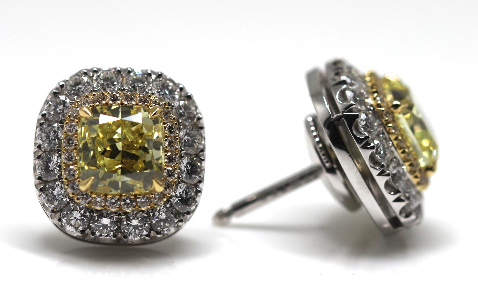 These GIA certified handmade diamond earrings are Fancy Intense Yellow with even colour throughout. One is round cornered modified brilliant weighing 1.11 carats VS 1 Clarity the other is 1.23 Carats VVS1 clarity this is a cushion modified brilliant