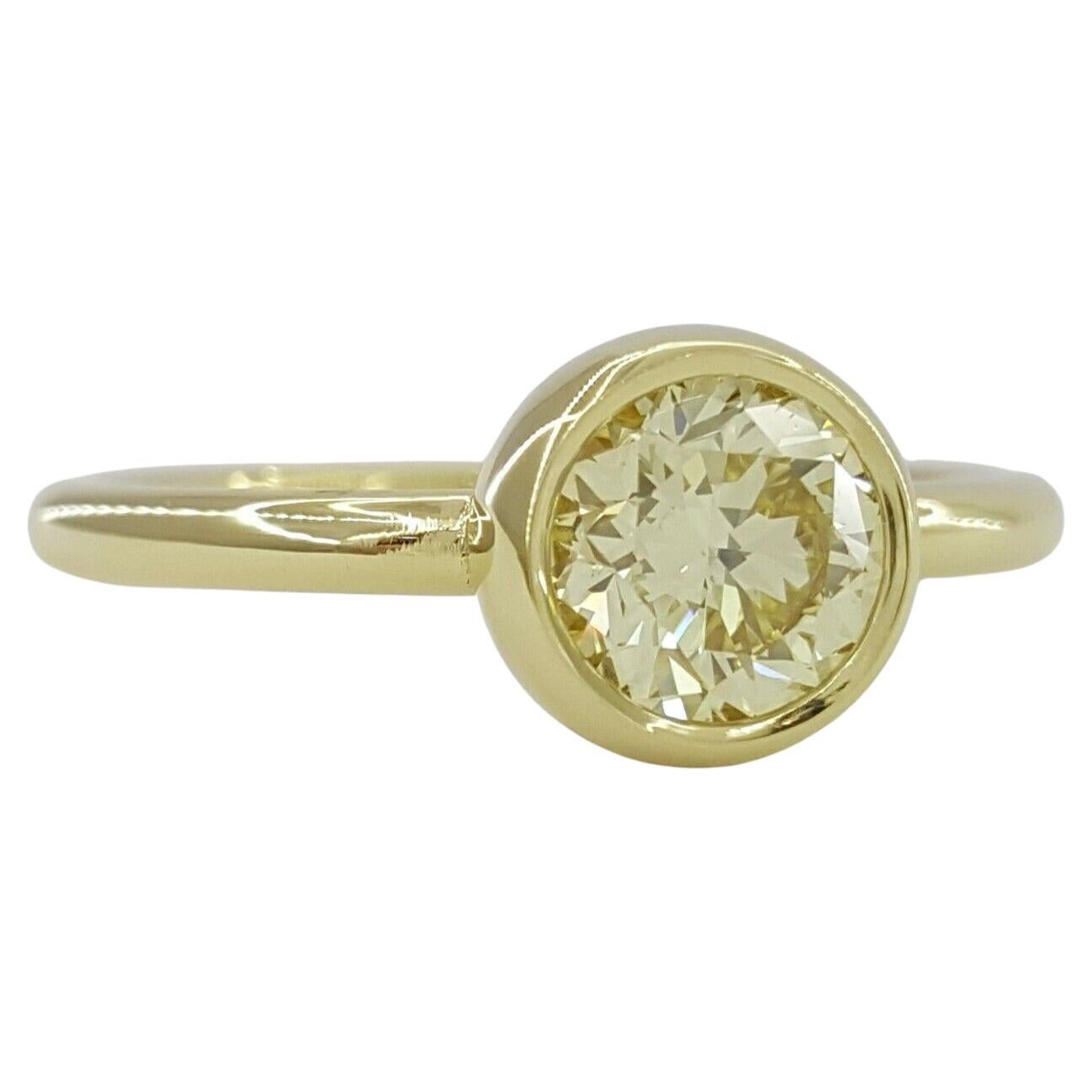 Yellow Gold Bezel Set Fancy Light Yellow Round Brilliant Cut Diamond Engagement Ring.



The ring weighs 4 grams, size 6, the center stone is a Natural Fancy Light Yellow Round Brilliant Cut diamond weighing ~ 0.75 ct, Even Fancy Light in color, SI1