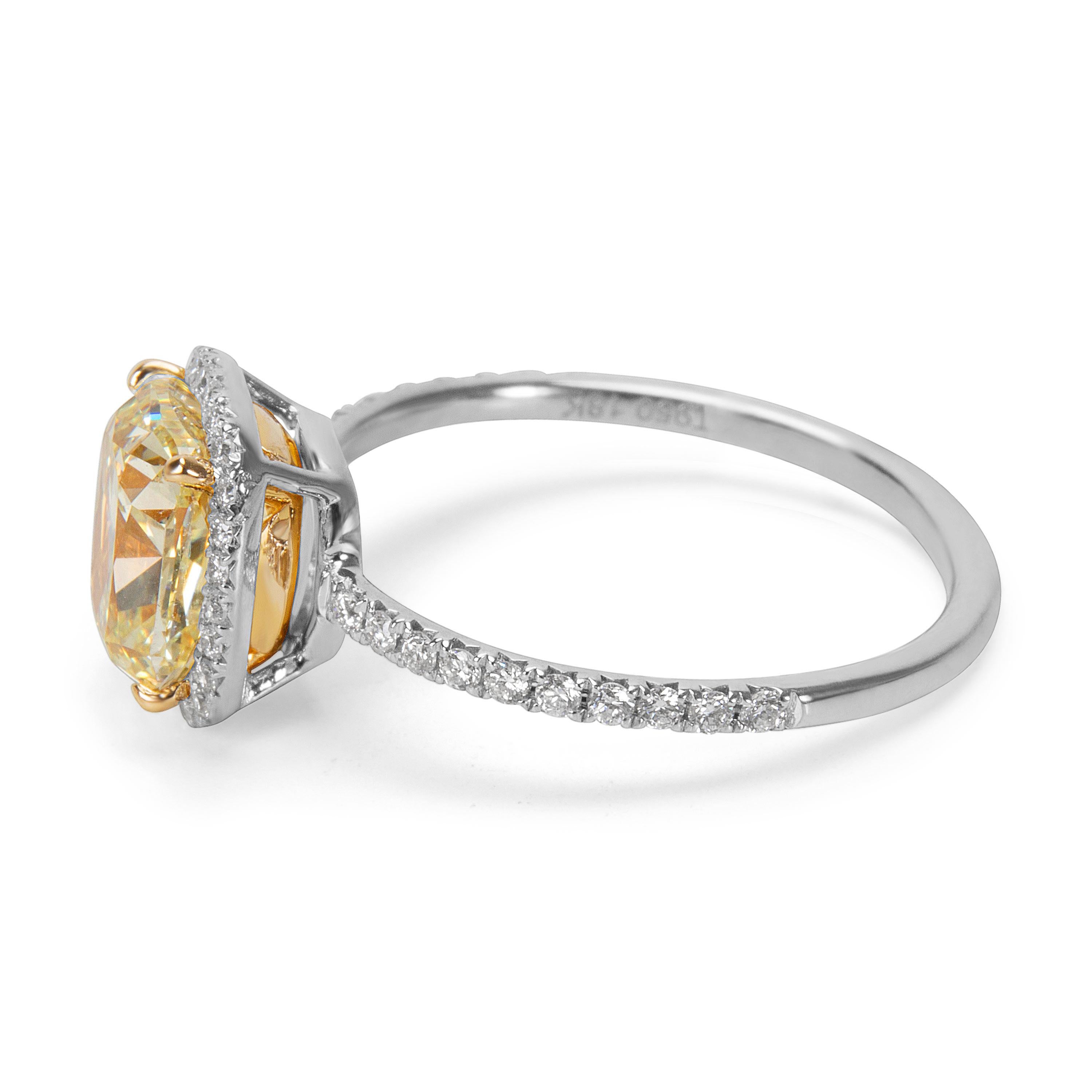 Brand new and unworn. GIA Certified. 2.15 carat Fancy Light Yellow cushion cut diamond with diamond halo in 18K yellow gold and platinum.

Center Stone  Type	        Diamond
Center Stone Weight  (cts)	2.15
Center Stone  Shape	        Cushion
Center