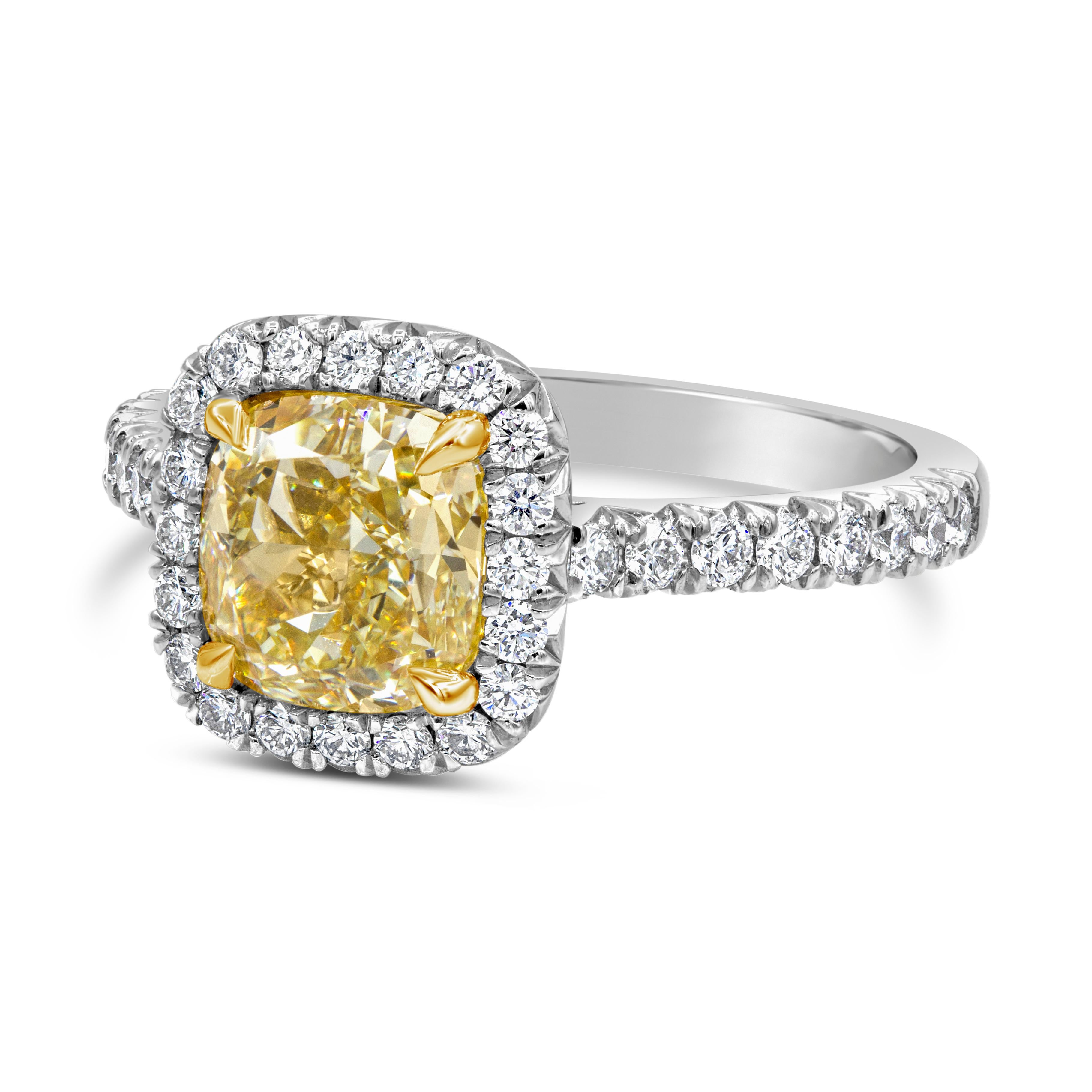 This halo engagement ring features a 2.01 carats cushion cut diamond engagement ring that GIA certified as Fancy Light Yellow in color and VVS1 clarity, set in four prong setting made in 18K yellow gold. Brilliant round diamonds surround the yellow
