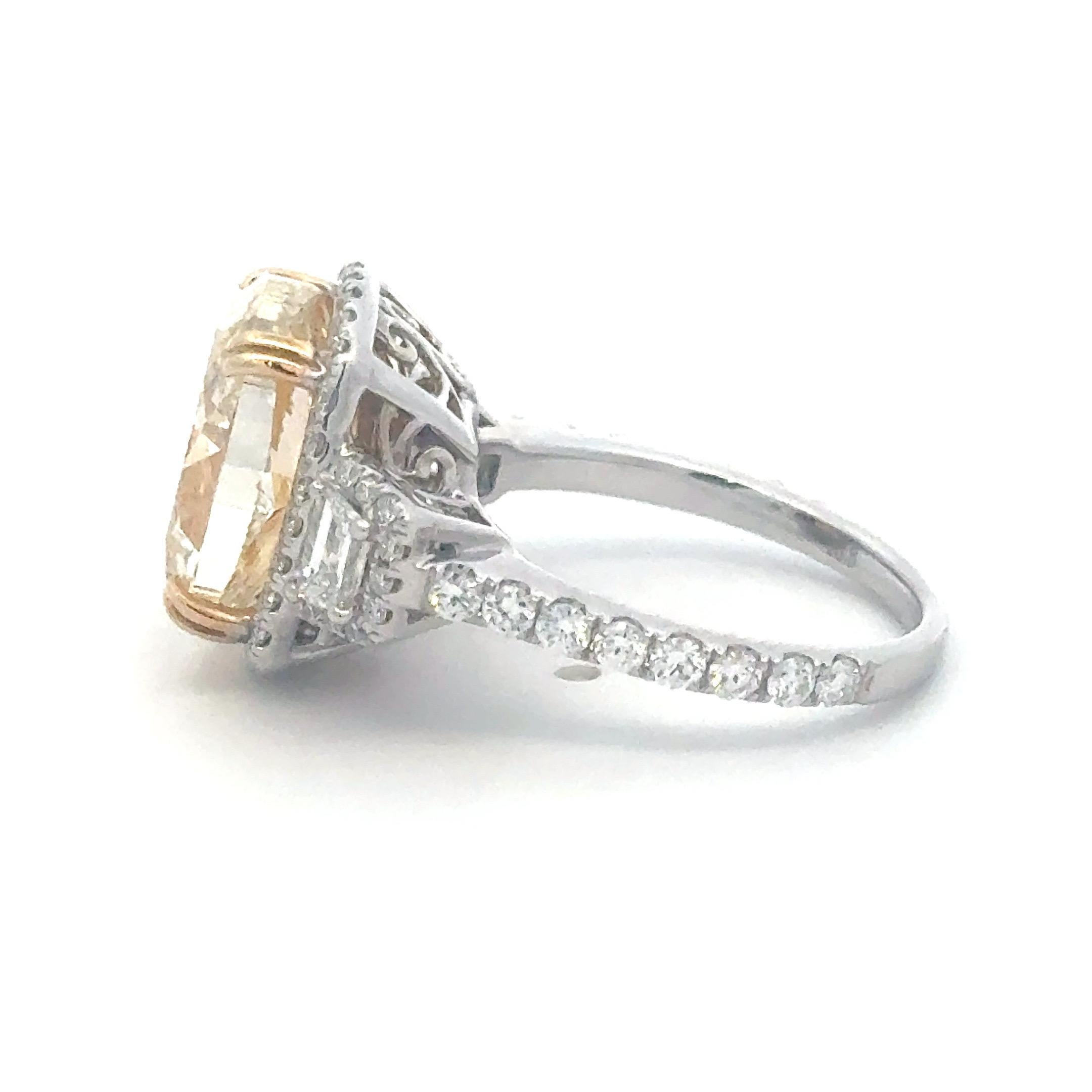 A striking and elegant statement ring showcasing a GIA-certified 6.01-carat Fancy Light Yellow oval brilliant-cut diamond, graded VS2 clarity. The captivating center stone is accented by 1.15 carats of additional diamonds, including baguette and