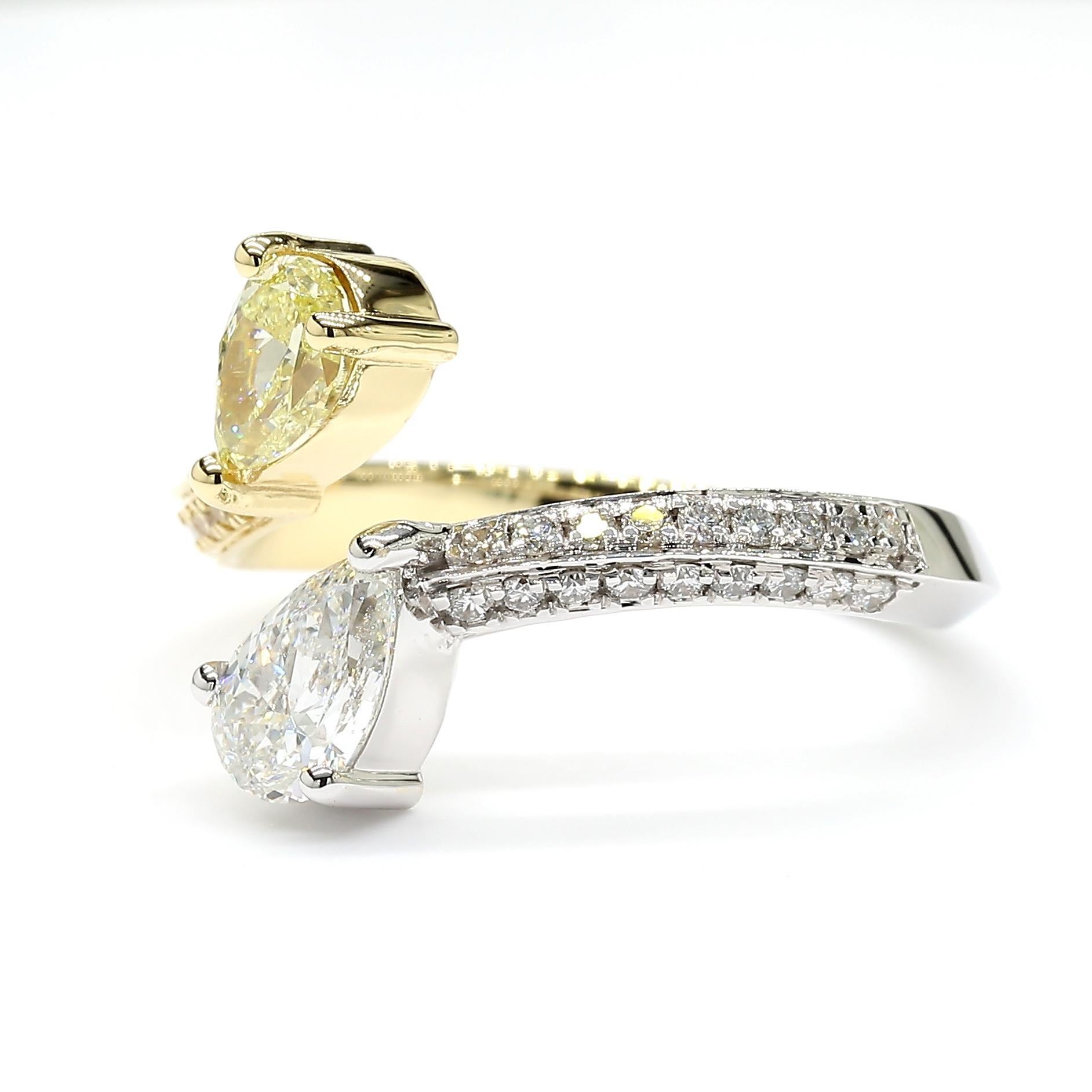 RareGemWorld's beautiful diamond ring. Mounted in a beautiful 18K Yellow and White Gold setting with a natural pear-cut yellow diamond and natural pear-cut white diamond. The diamonds are surrounded by natural round yellow diamond melee and natural