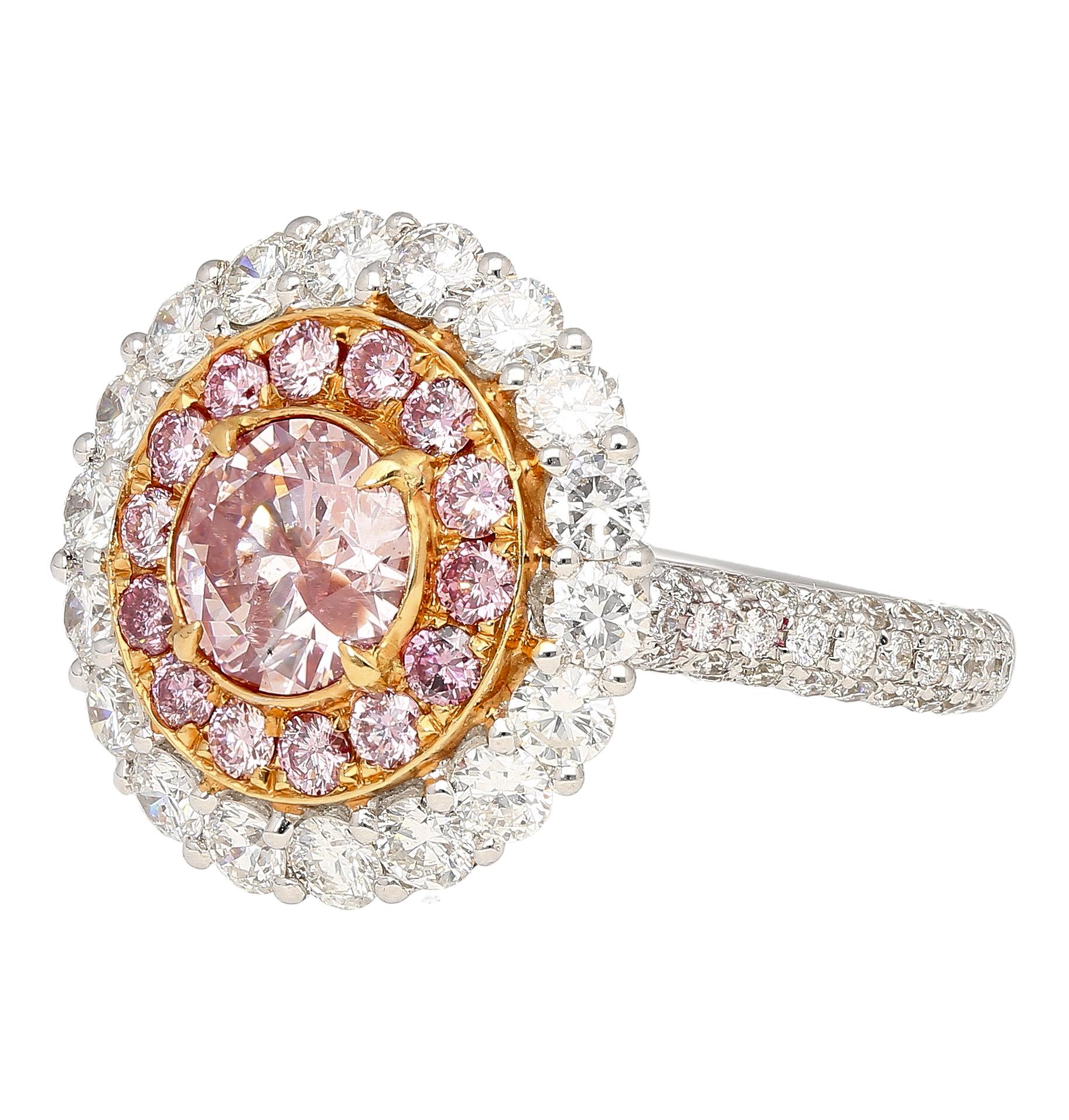 GIA certified round cut fancy pink diamond with multi colored double diamond halo ring crafted in 18k white & rose gold. The main pink gemstone and the 14 round cut pink diamonds are prong set in 18k rose gold. Surrounding the pink diamonds are 96