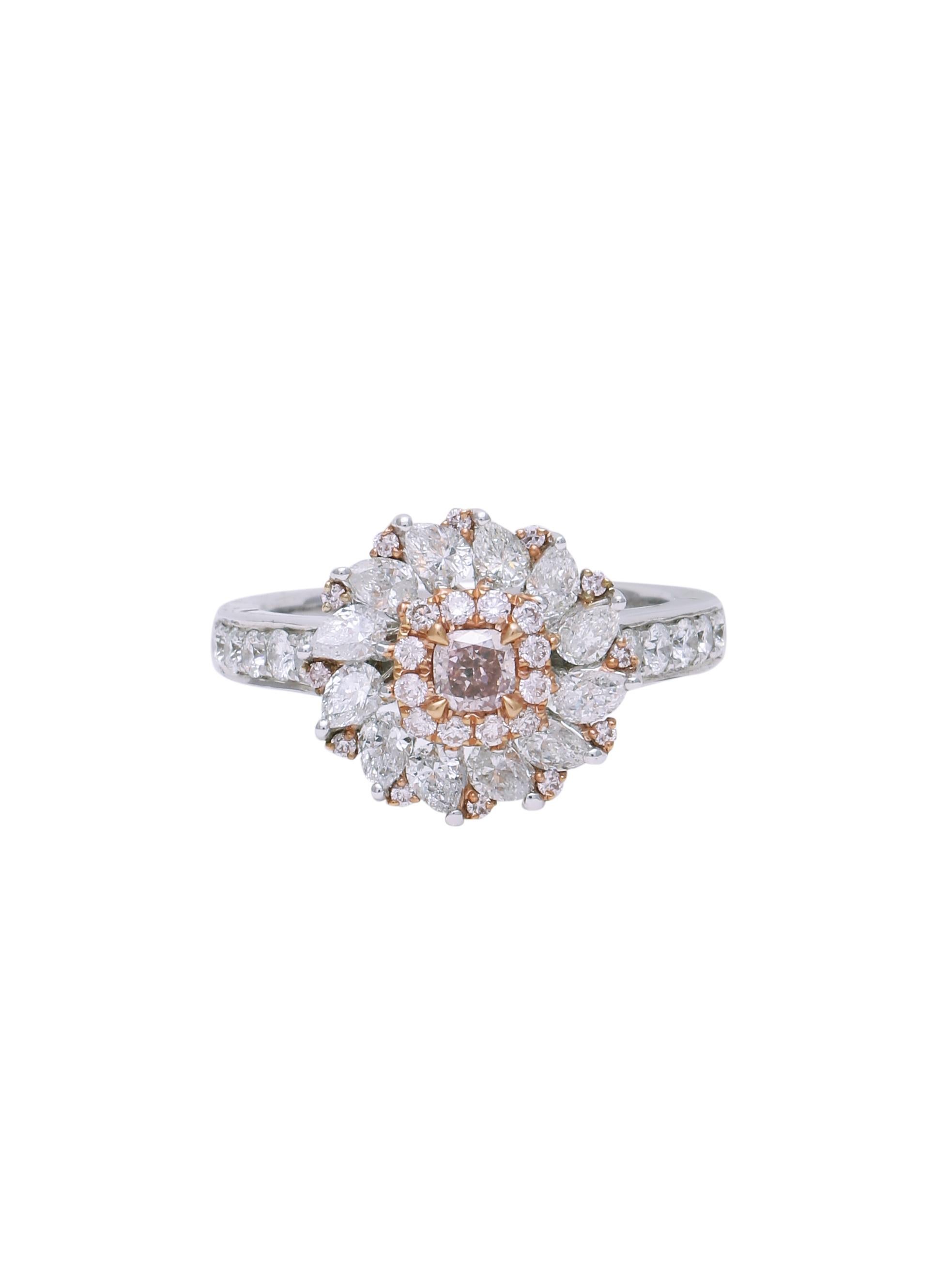 A beautiful pink diamond ring with a 0.25 carats GIA Certified Fancy Pink Diamond in the centre and a cluster of smaller white and pink diamonds around and with a line of Pear shape diamonds too. The cluster of Diamonds around the centre diamond