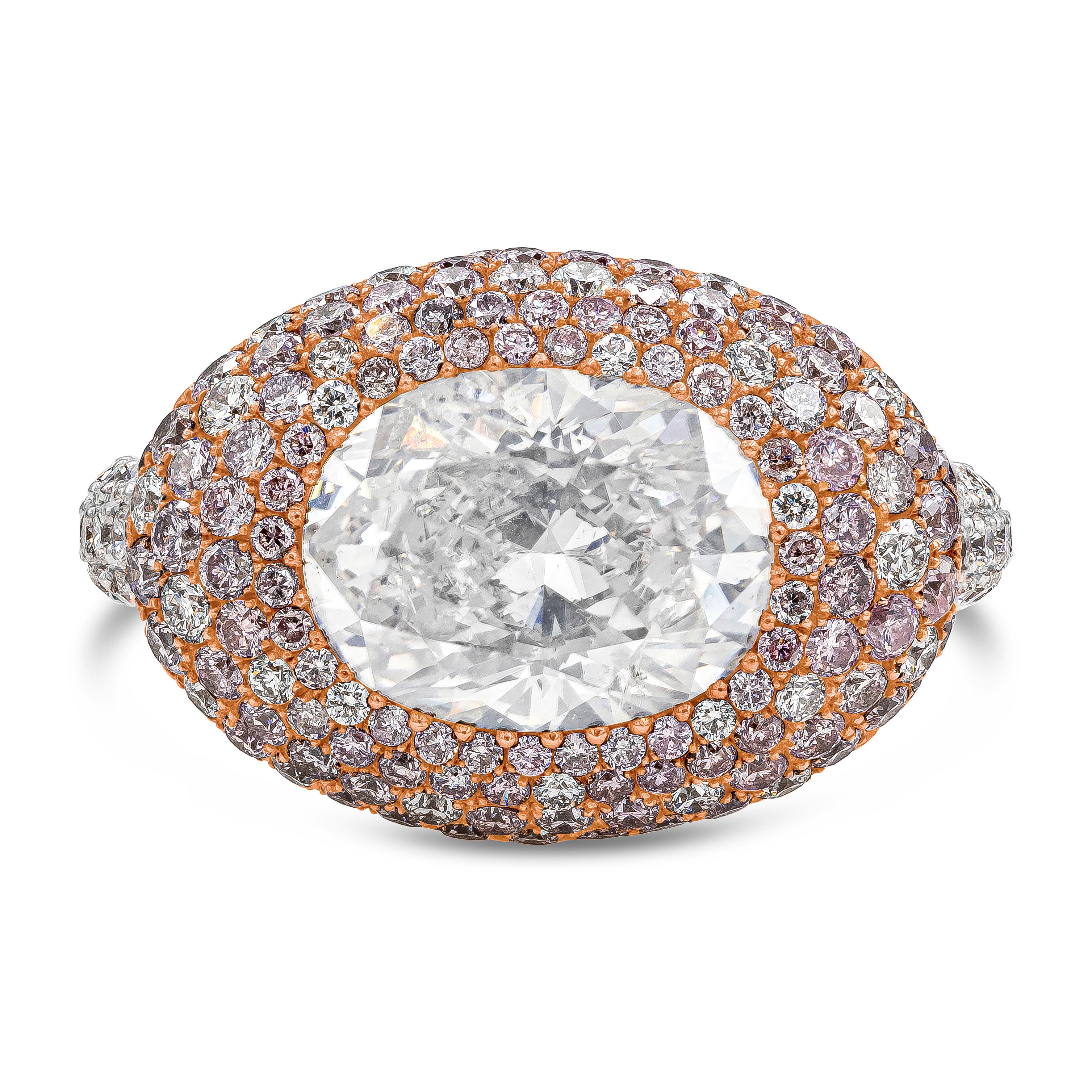 A luxurious and fashionable dome cocktail ring showcasing a 4.02 carat oval cut diamond certified by GIA as Natural Fancy White color. Set in a beautiful dome micro-pave set with brilliant white and pink diamonds that continue down the shank of the