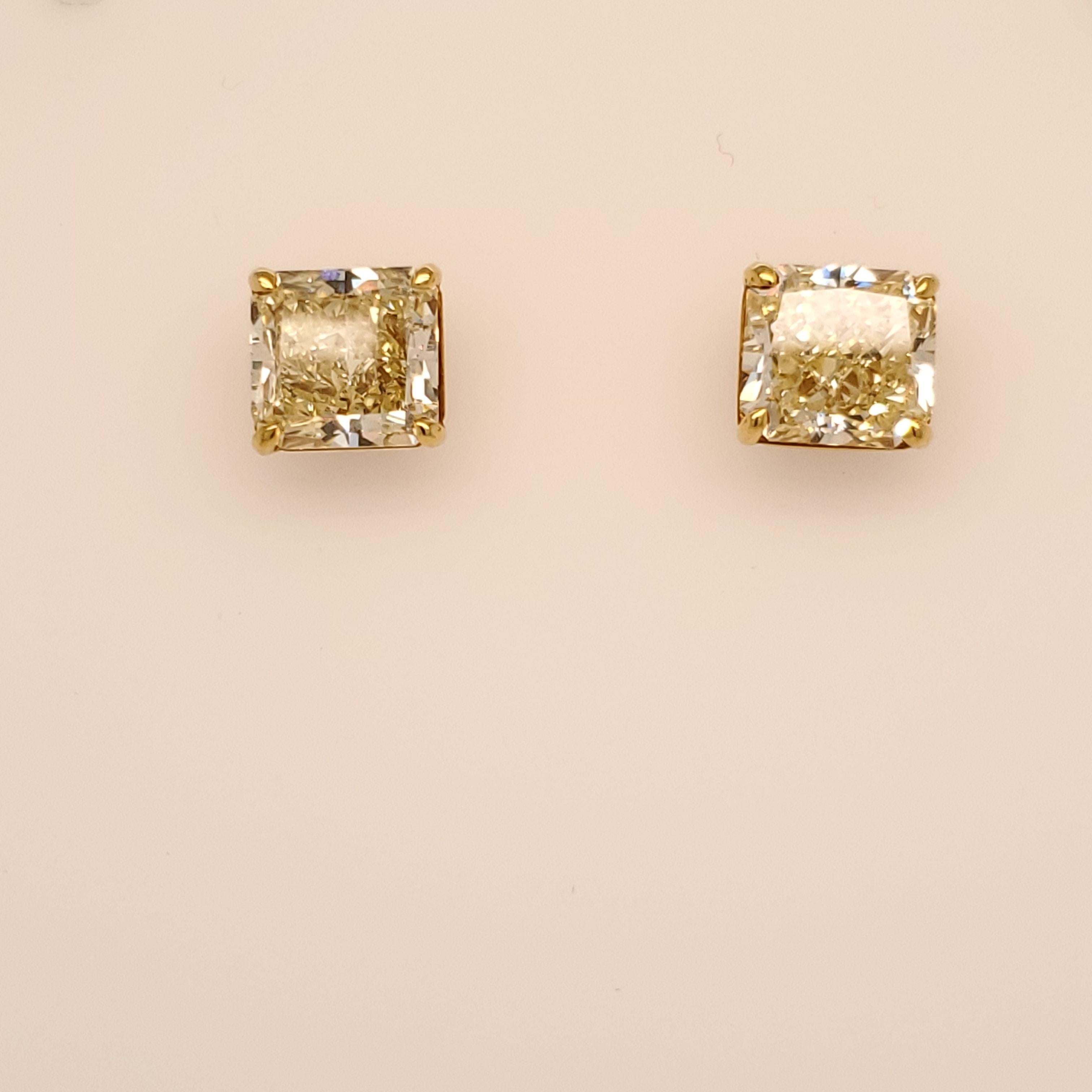 Both Stones are GIA certified Fancy Yellow VS1 quality. Both were cut in our factory to be an exact match of radiant cuts. One weighs 5.15 carats and the second weights 5.16 carats. Set in a 18 karat yellow gold hand made setting. 