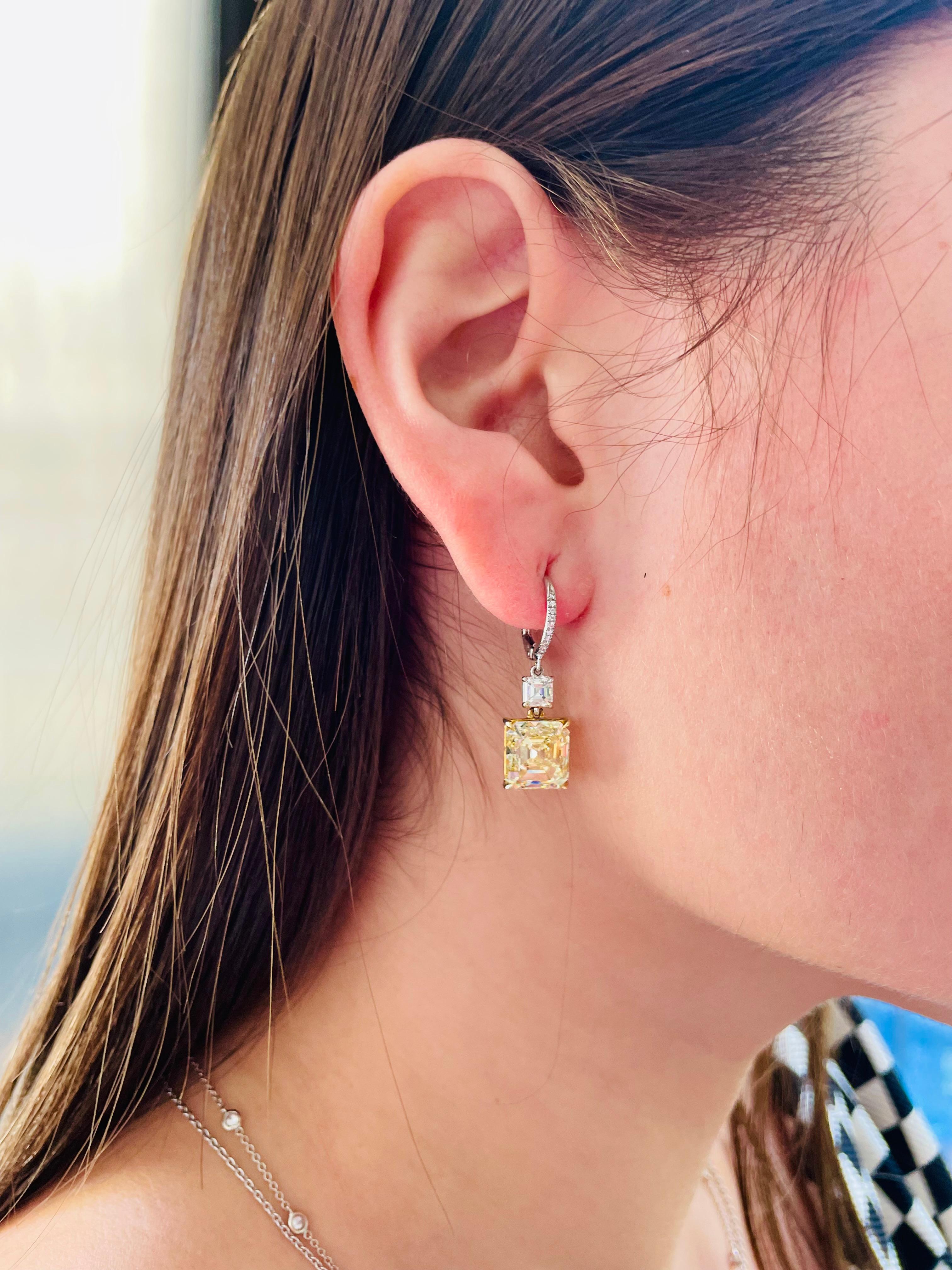 From the J. Birnbach Collection of fancy yellow diamonds, these sophisticated drop earrings showcase 5.11 carat and 5.02-carat Fancy yellow asscher-cut diamonds that drop from two white 0.70-carat asscher diamonds. These elegant earrings made with