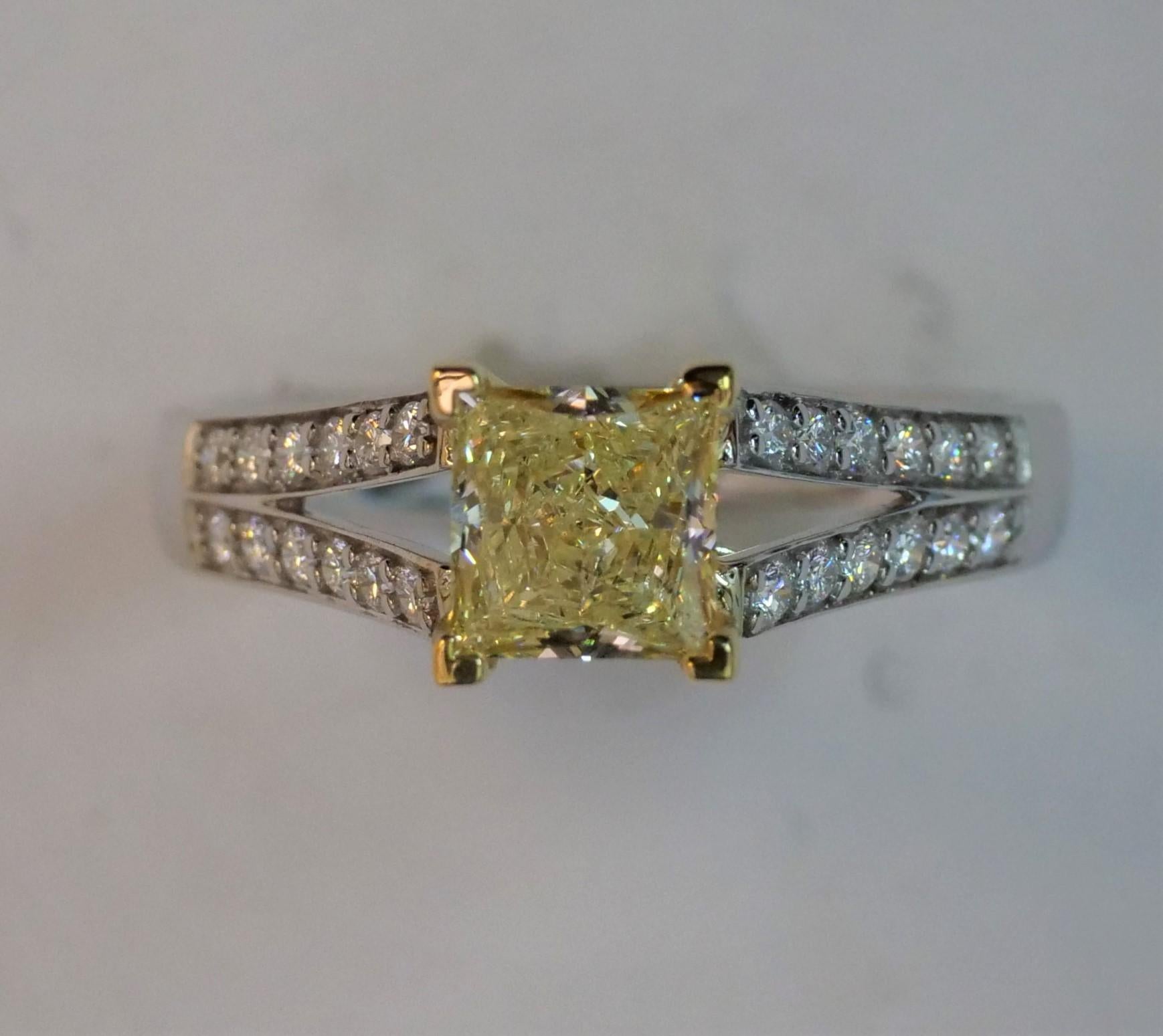 Raregemworld's Natural GIA Certified Fancy Yellow 1.08 carats Princess Cut Diamond Surronded by 24 round white diamonds weighting 0.24 carats.  Set in 18K White and Yellow Gold.

Size 6.5 (sizable upon request)