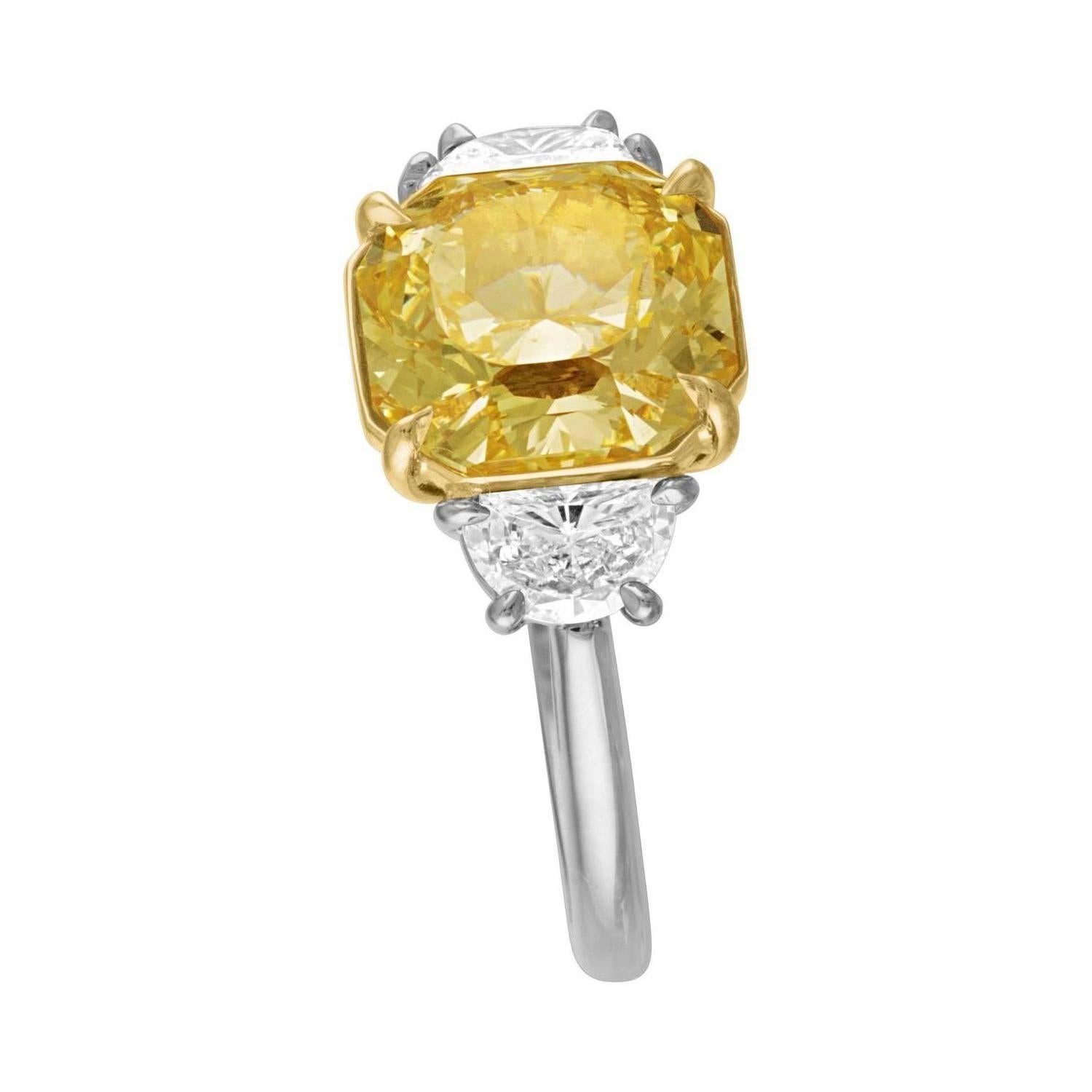 4.09 Carat Cushion Certified by the GIA as Fancy Yellow in Color and VS1 in Clarity.
GIA Certificate Number is 2173803488.
The Cushion is set in Two Tone Mounting, 18K Yellow Gold and Platinum. To the side of the 4.09 Carat Cushion Cut there are Two
