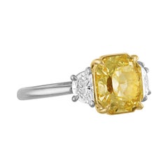 GIA Certified Fancy Yellow 4.09 Carat Cushion Cut Diamond Three-Stone Ring