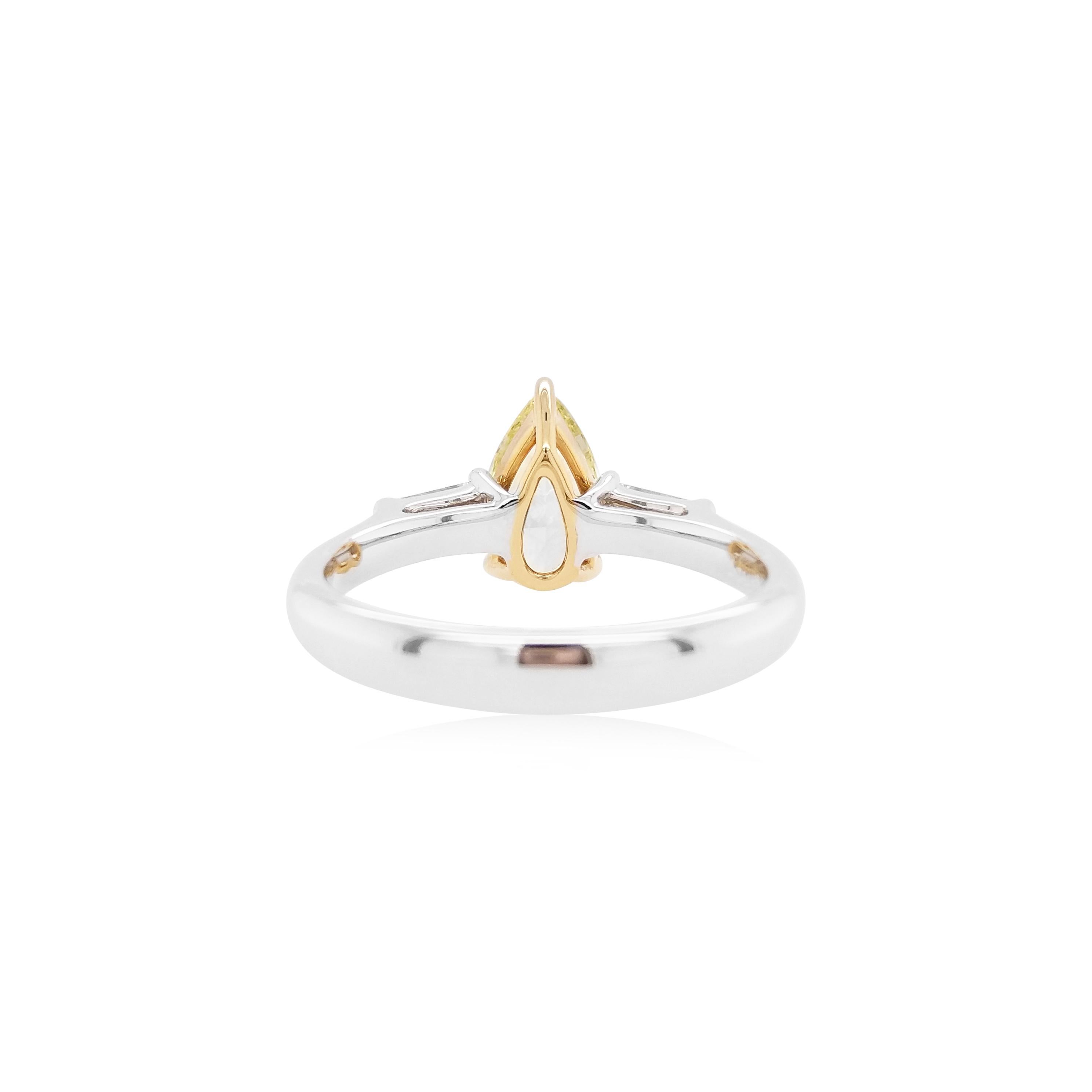 This charming 18K gold ring features a high-quality Pear drop Fancy Yellow Diamond at the centre, each side set with a tapered baguette White Diamonds. Unique and striking, this exceptional ring will add a touch of high glamour to any look.
-	Centre