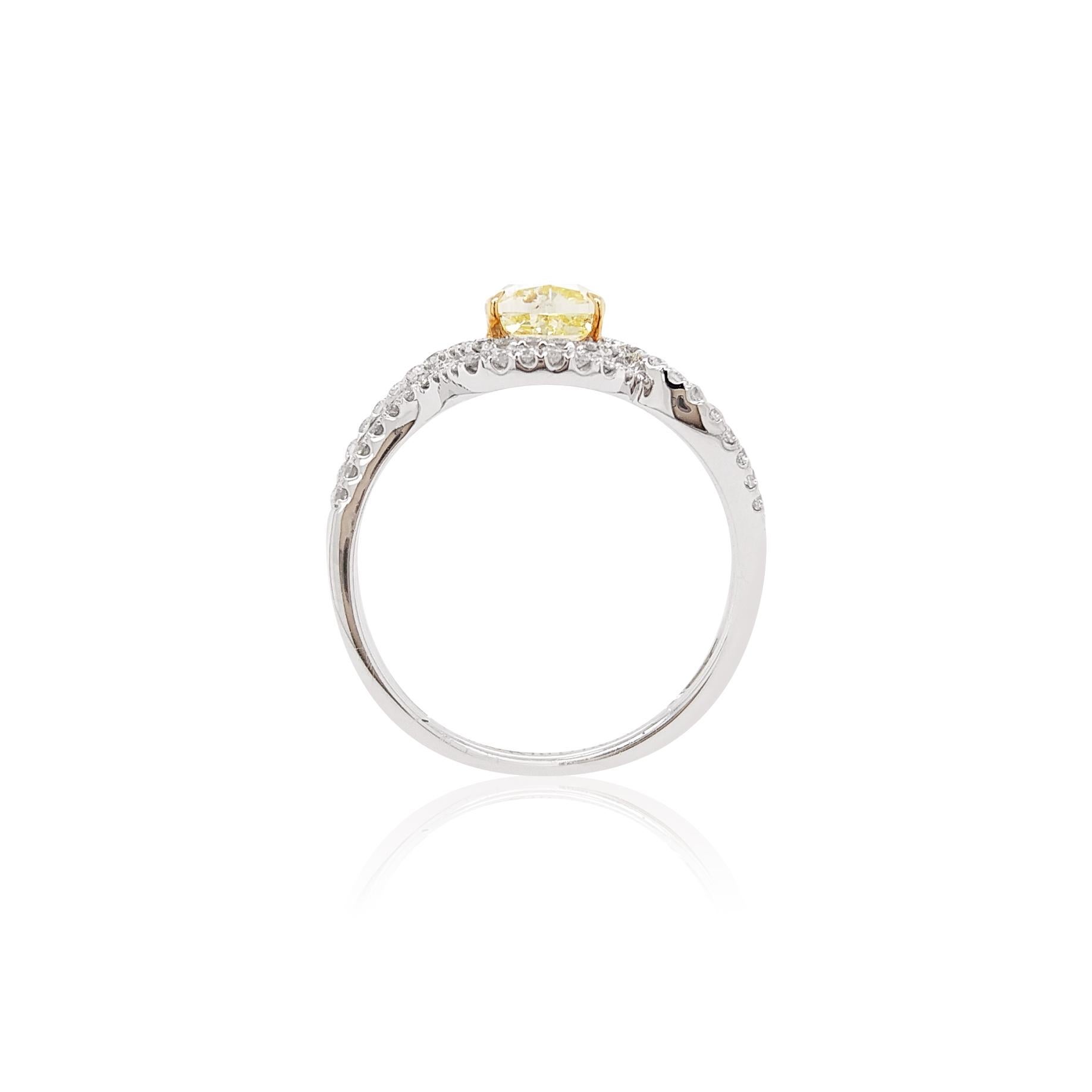 This scintillating ring features a brilliant Fancy Yellow Diamond set amongst contemporary White Diamond swirls. The rare natural golden yellow diamond featured at the centre of this ring is the perfect way to add a subtle pop of color to your
