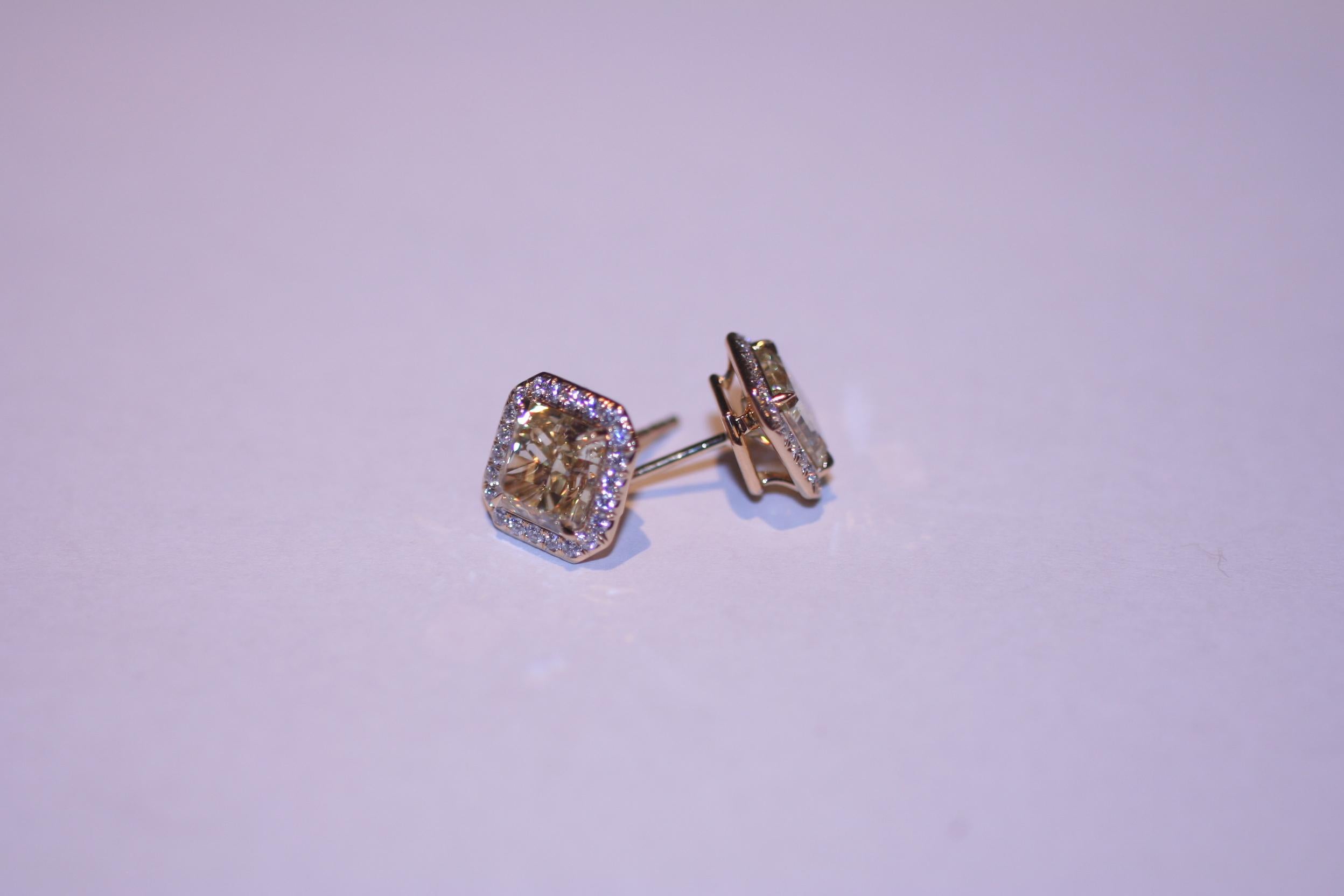 Stunning Handmade 18K Yellow Gold Diamond Earrings with 54 Round Brilliant cut diamonds D-E-F color VS clarity weighting appx. 0.39 carat, accompanied by center diamonds:

RAD 2.18ct Fancy Yellow VVS2 GIA certificate no. 2215147504
RAD 2.20ct Fancy