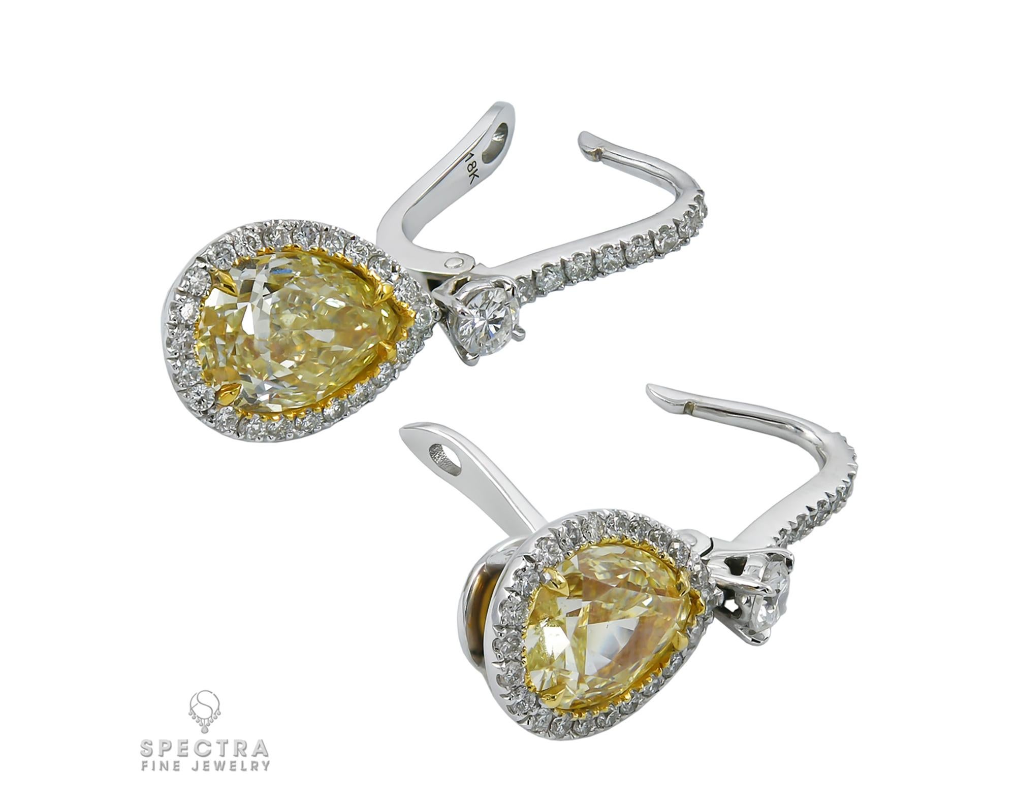 Beautiful drop earrings, decorated with two pear-shape fancy light yellow diamonds accented by white round diamonds, mounted in platinum and 18k yellow gold. 
Yellow diamonds are accompanied by the GIA certificates, stating that they are 3.32 carats