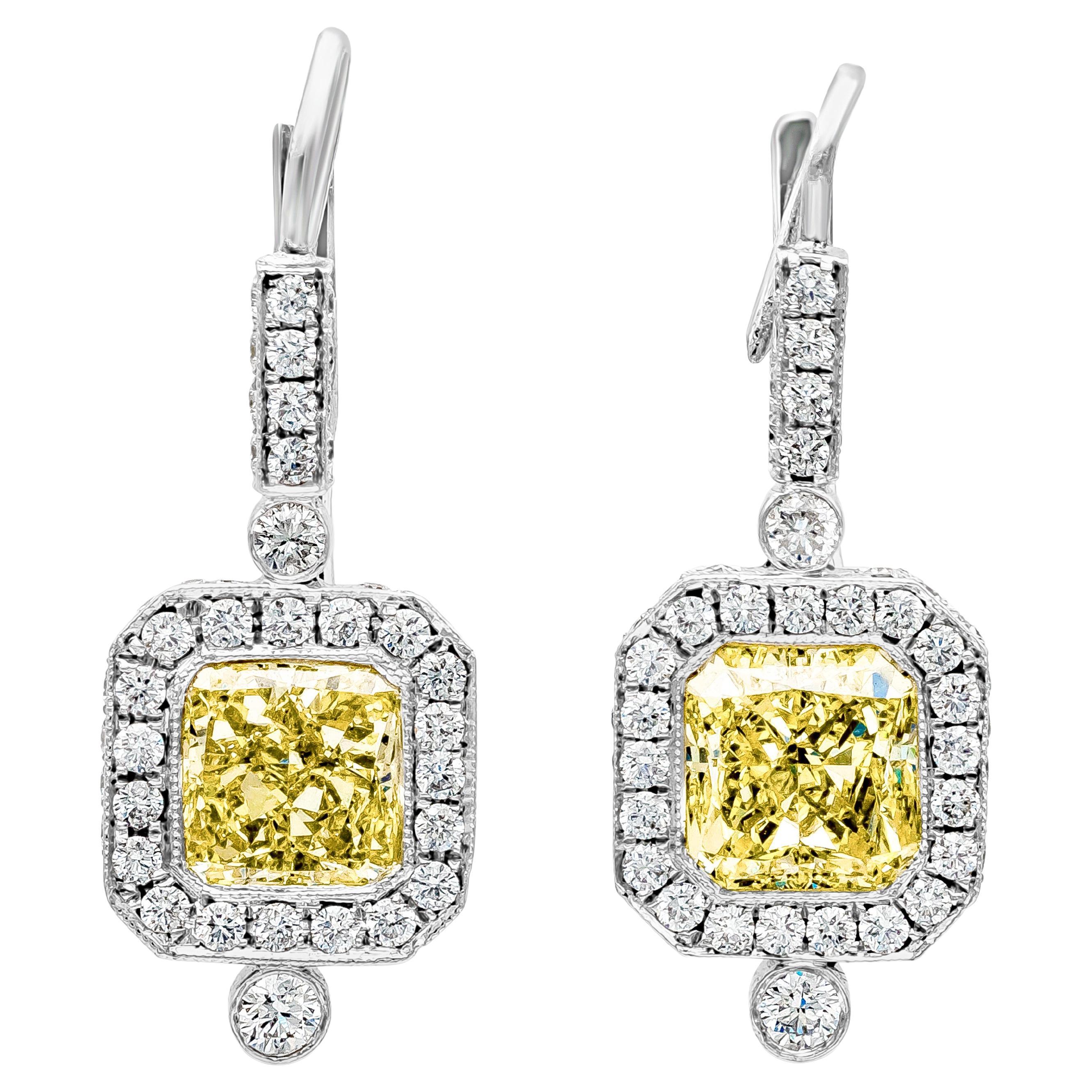 An antique style design dangle earrings showcasing two perfectly matched GIA Certified Radiant Cut diamonds weighing 3.04 carats total, VS1-SI1 in Clarity. Surrounded by round diamond in a halo design, Made in Platinum

Roman Malakov is a custom