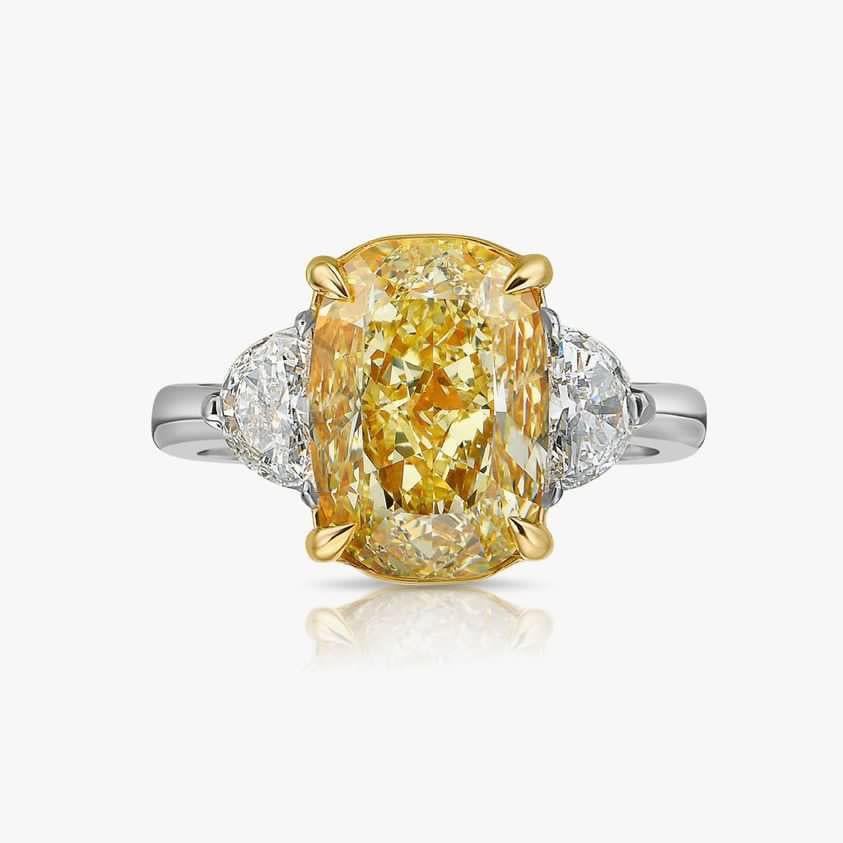 An exquisite glamour design, so chic and refined, in 18k gold with a stunning GIA certified  natural fancy yellow diamond of 5.010carats, VS2 clarity, in cushion cut, and two side natural diamonds, in half moon cut of  each 0,60 carats x 2, with a