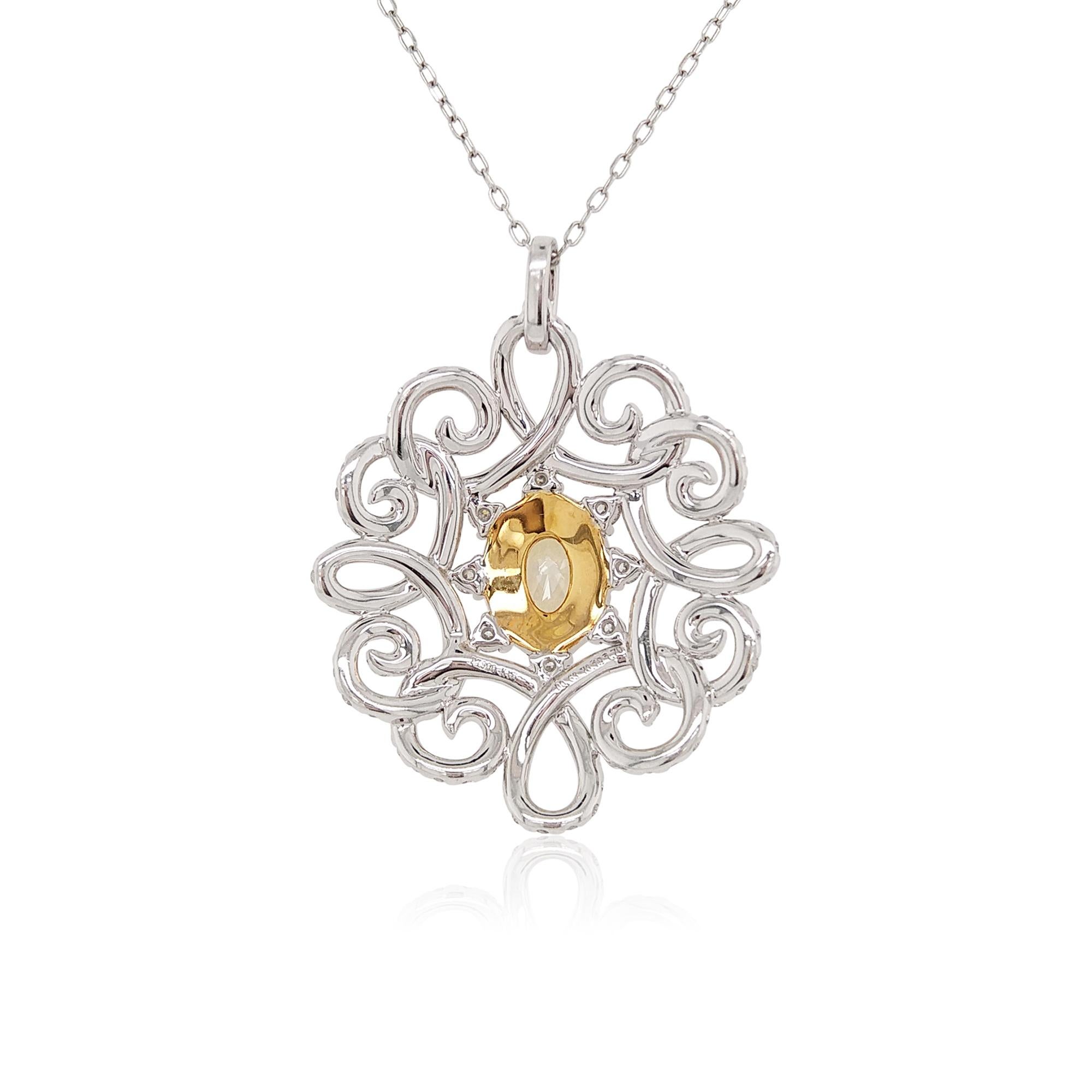 This bold pendant features a GIA certified Fancy Yellow diamond in its centre, within a halo of brilliant small Yellow diamonds, and intricate sparkling White diamonds twists. This delightful necklace will add a sumptuous pop of colour to any outfit