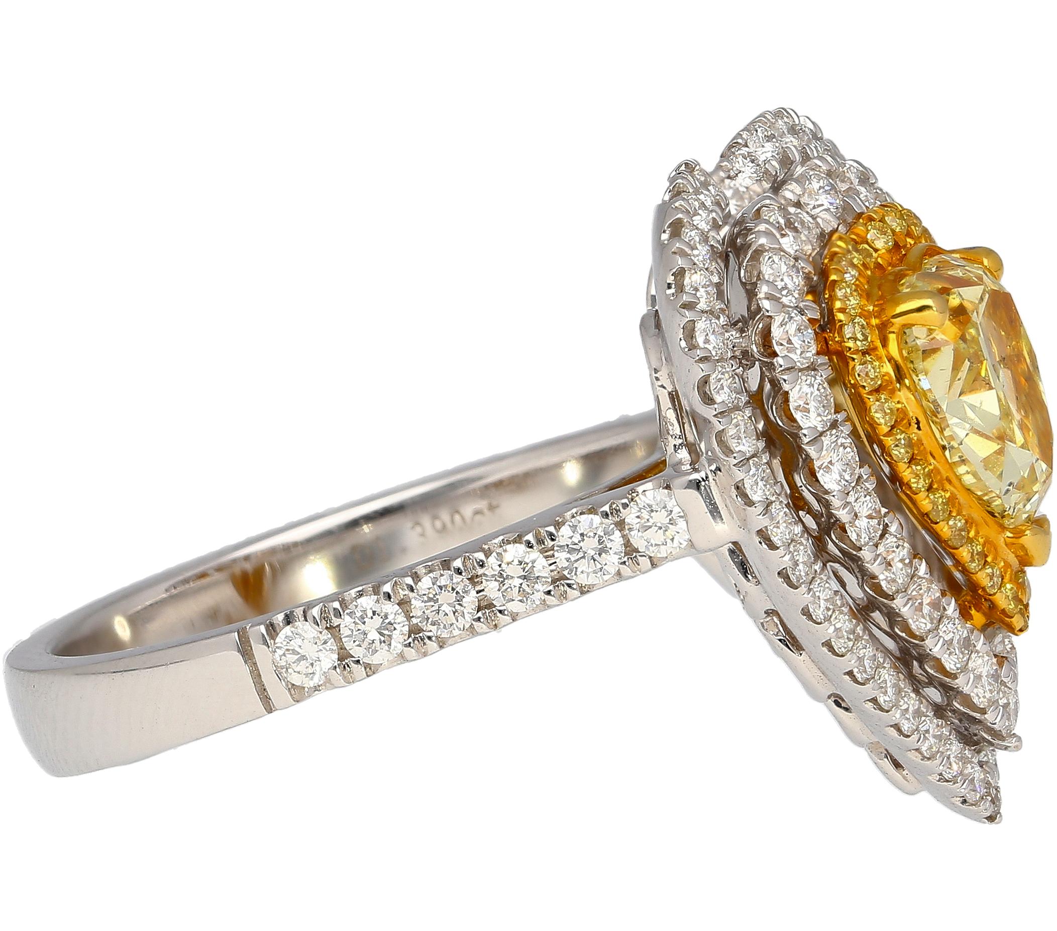 18K white and yellow gold natural diamond ring. Centering a GIA certified 1.39 carat Fancy Yellow heart shape diamond. Adorned with three round cut diamond halo that beautifully curve to form a wide frame heart shape motif.

A heart motif ring with