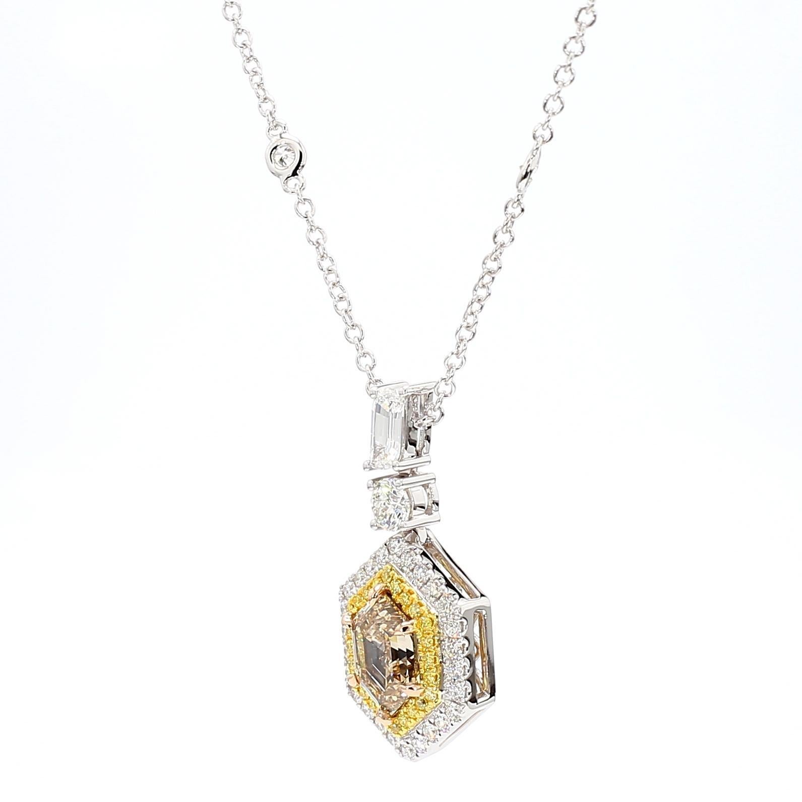 RareGemWorld's beautiful GIA certified diamond pendant. Mounted in a beautiful 18K Yellow and White Gold setting with a natural hexagon cut yellow diamond. The yellow diamond is complimented by a natural white flame cut diamond which are surrounded