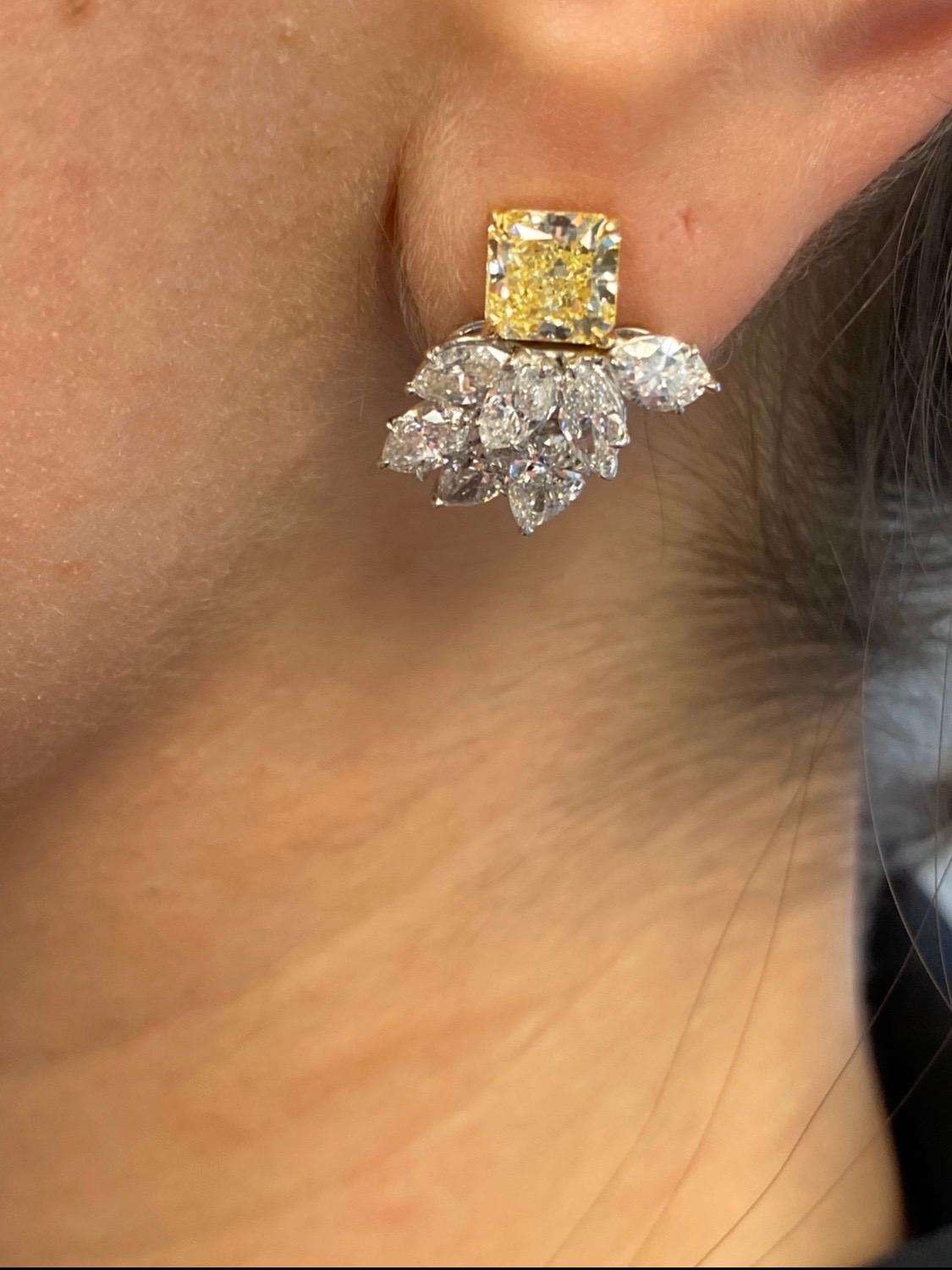Spectacular earrings featuring GIA Certified 1.29 Carat and 1.30 carat Fancy yellow square cut diamonds. 
Square cut diamonds are cherished for their remarkable brilliance and beauty. The astonishingly cut and amazingly beautiful stones used in this