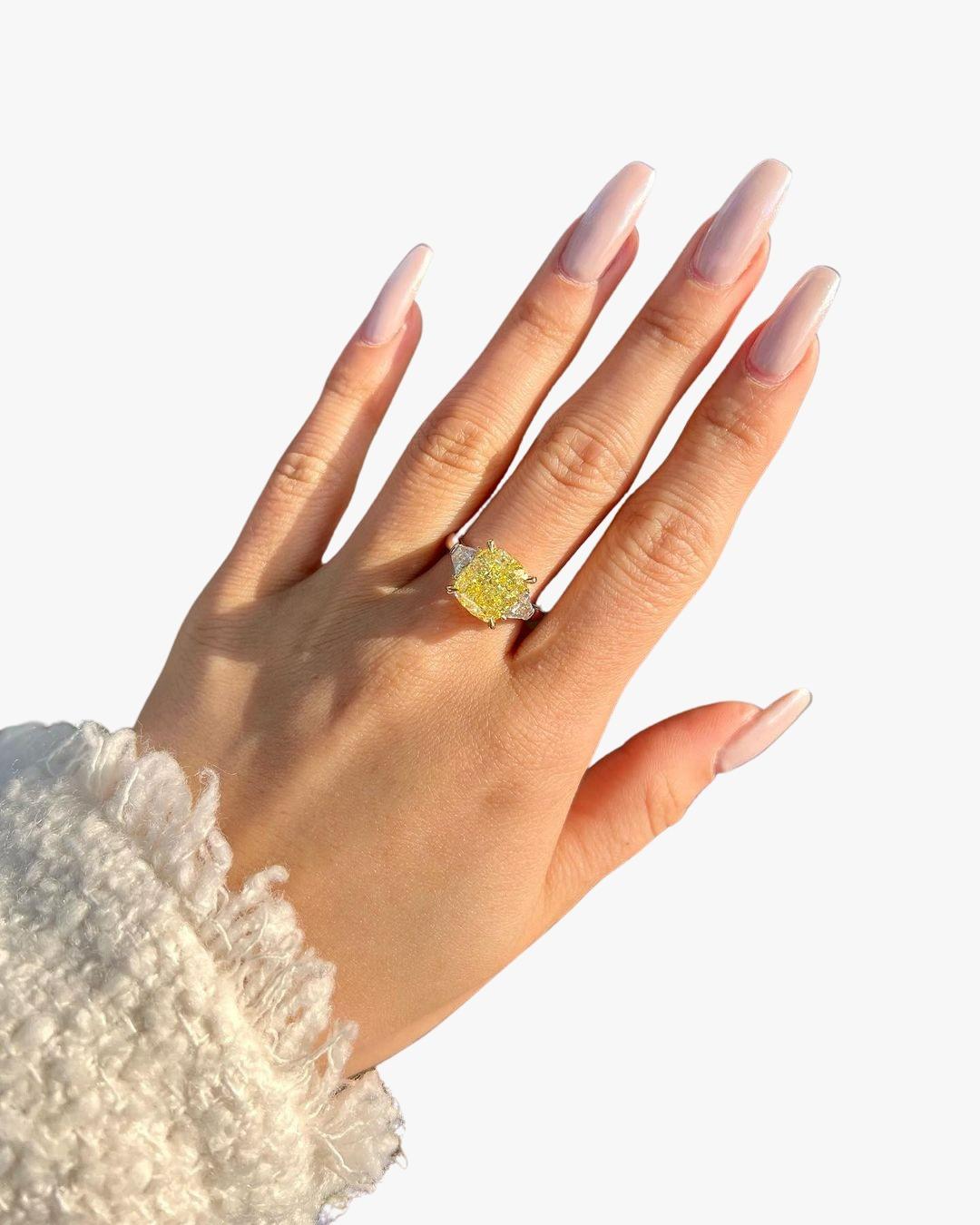 A STUNNING yellow diamond ring!

GIA certified 4.30 carat Radiant cut Fancy Yellow, FLAWLESS Clarity center diamond.

.65 carats of white side diamonds.

Custom platinum and 18k yellow gold mounting.

Size 6, this ring can easily be resized.