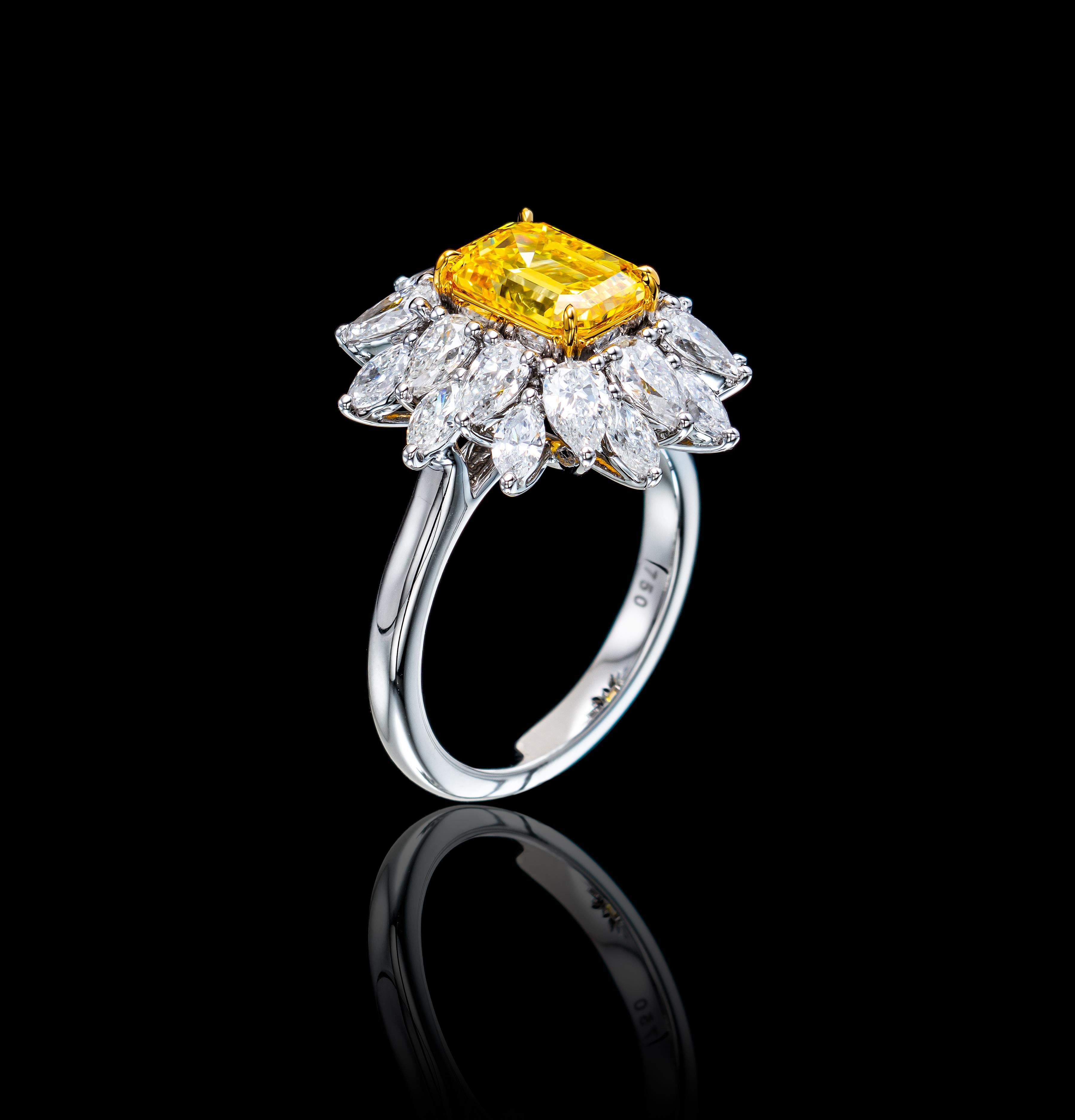  Inspired  by the Victorian era, this hand crafted floral ring is graced with timeless glamour. 
Showcasing a dazzling 2.01 Emerald Cut Fancy Vivid Yellow Diamond / VS2 and accented by 2.29 Carat of 20 E-F/ VVS mixed shaped diamonds. 
The