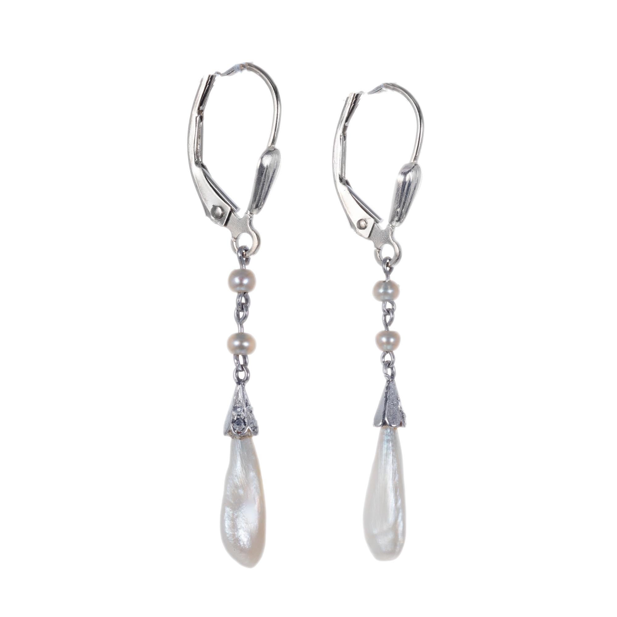 Early 1900's Antique pearl and diamond dangle drop earrings. GIA certified natural freshwater pearls accented with 12 old mine cut diamonds. 14k white gold with Euro tops. 

2 natural white baroque freshwater pearls GIA Certificate # 2205901432
4