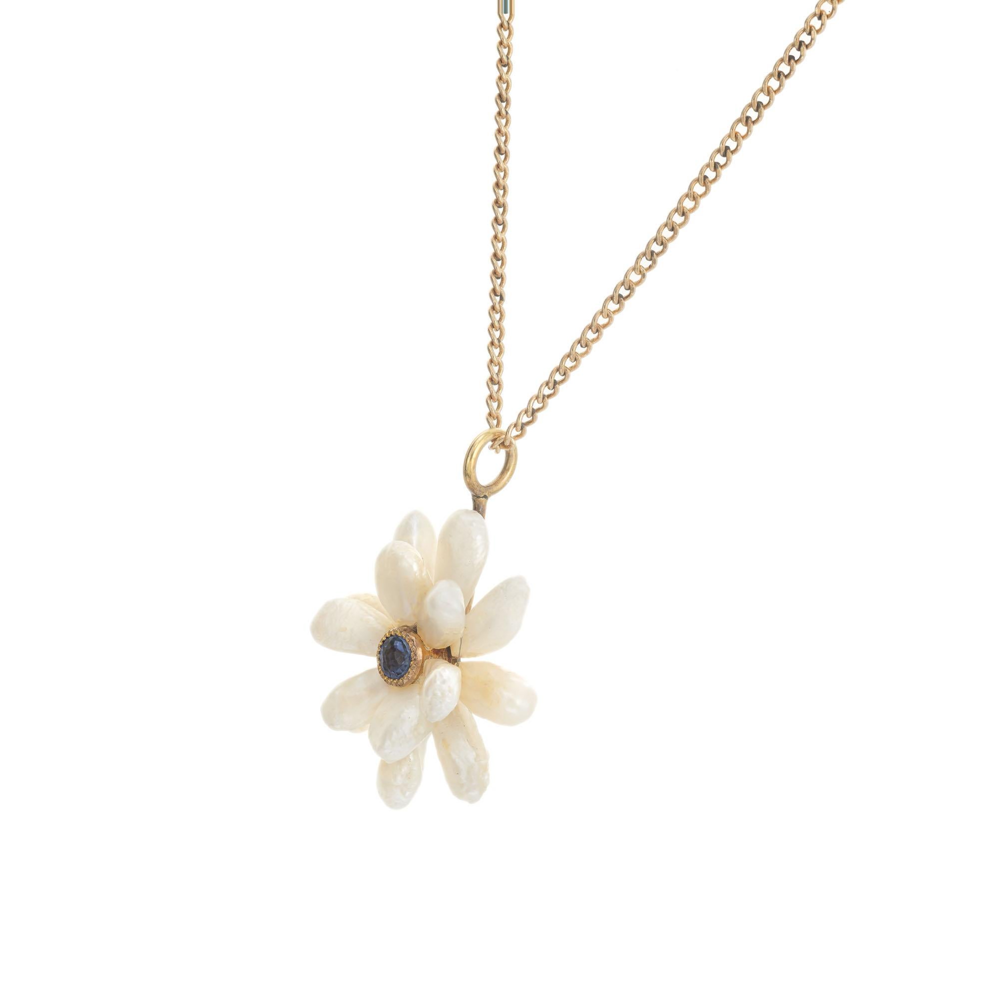 1960's freshwater Baroque pearl and sapphire flower pendant necklace. GIA Certified 14 natural baroque freshwater pearls with around center Montana sapphire, in 14k yellow gold. 19 inches in length

14 natural white freshwater baroque pearls,