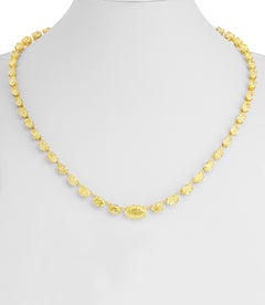 Collar tipo «tenis» con diamantes ovalados amarillos de fantasía, certificado por el GIA