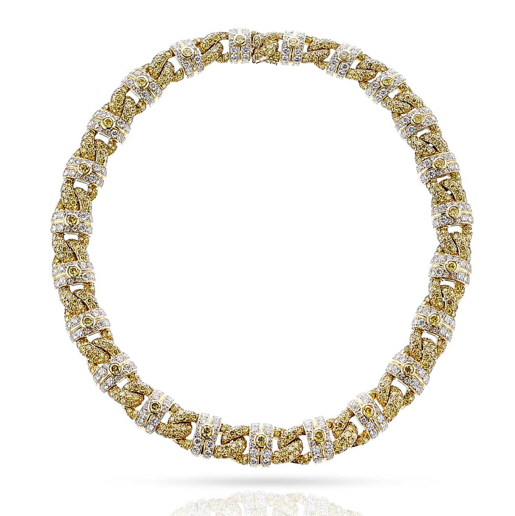 A GIA Certified Natural Yellow and White Diamond Necklace made by GRAFF. The round yellow diamonds are bordered by two rows of round colorless diamonds. The necklace is stamped 750, for 18k gold with French assay marks and GRAFF. The total weight of