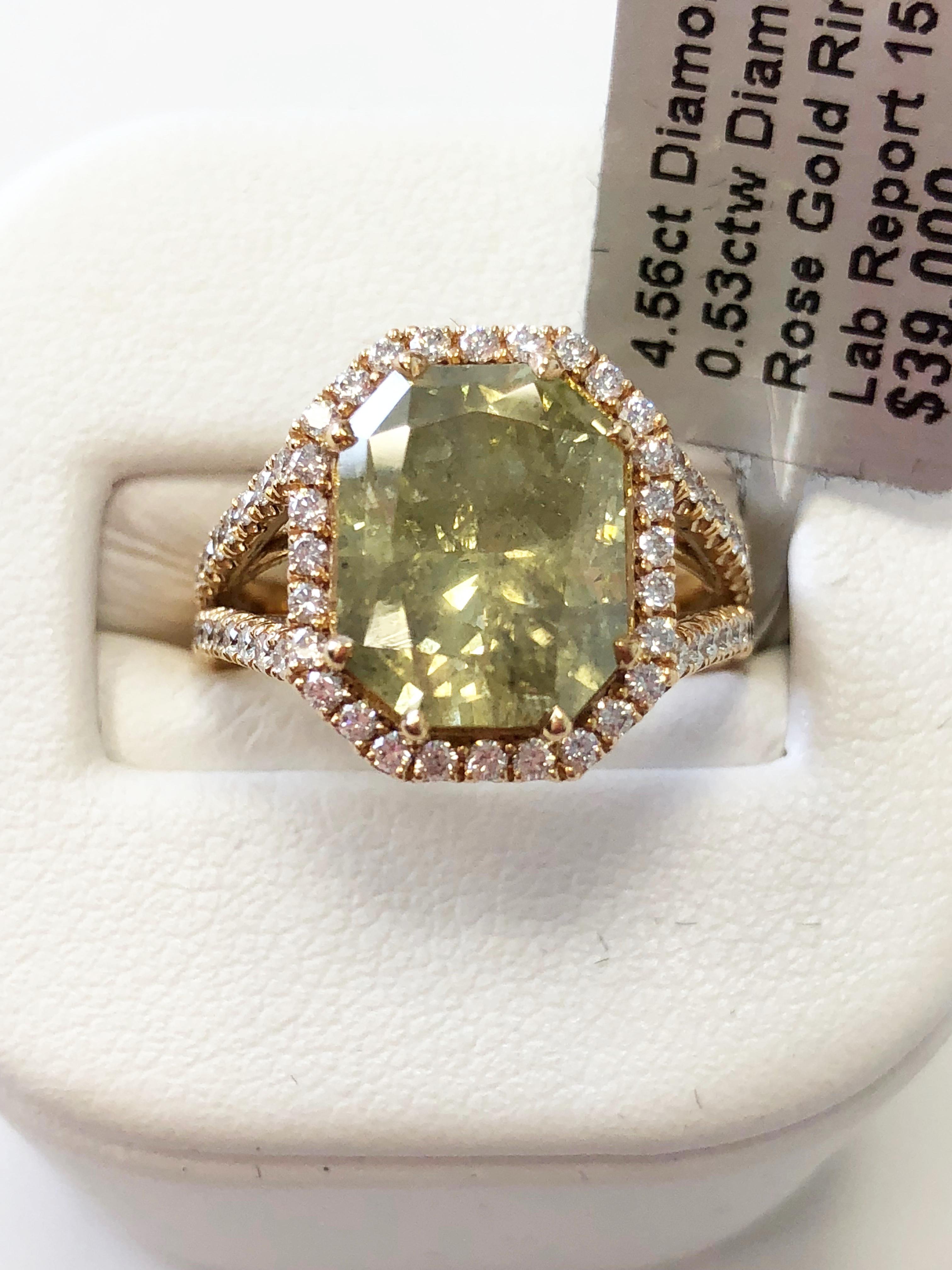 Gorgeous 4.56 carat green radiant diamond surrounded by 0.53 carats of good quality white diamond rounds.  This stunning ring is size 6 in 18k rose gold.  The diamond is the perfect shade of green and stands out in the rose gold mounting.  Ideal for